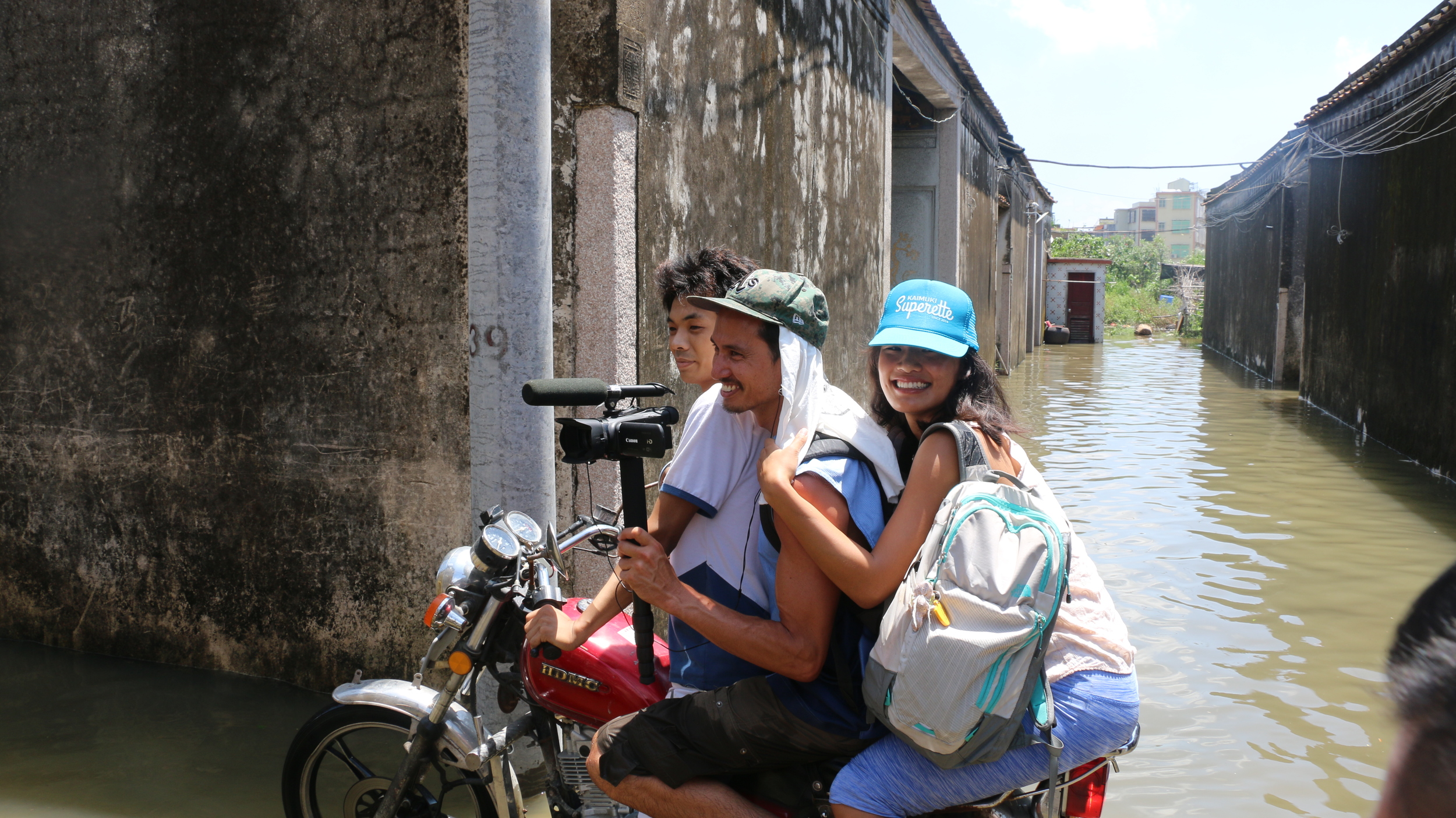 Gino & Linda braving the flood to record my maternal village