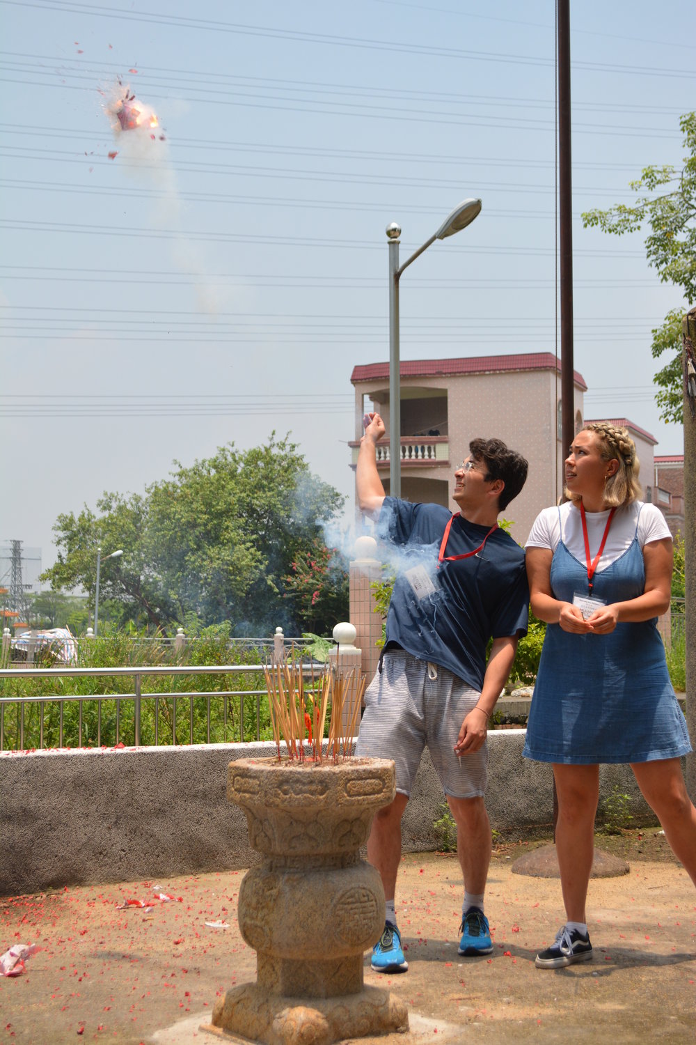 Cousins Olly Goodman and Gaby Koc-Spadaro throwing firecrackers at their grandmother's village in Sanshui