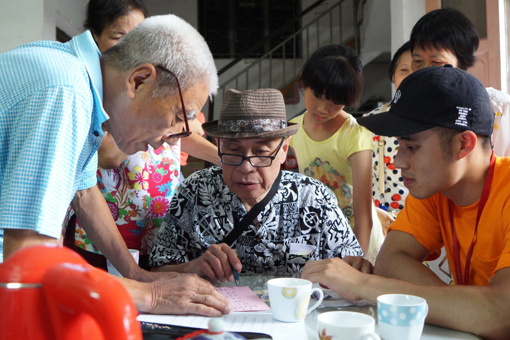Looking at genealogy books in Scott Leung's paternal grandfather's village in Shunde