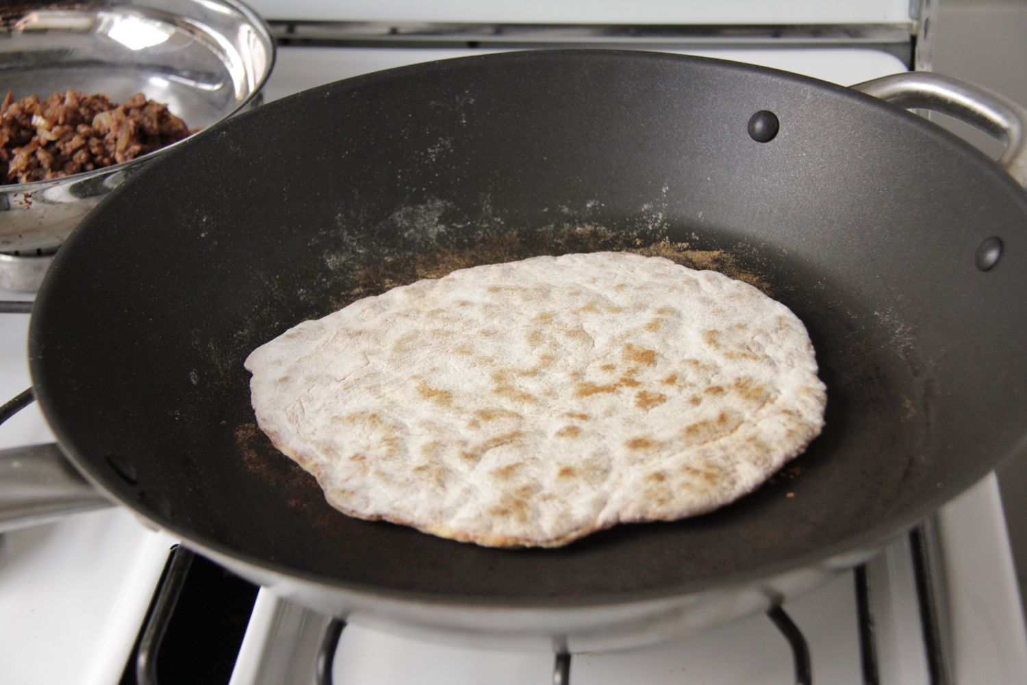 Cooking the fflat bread in a frypan