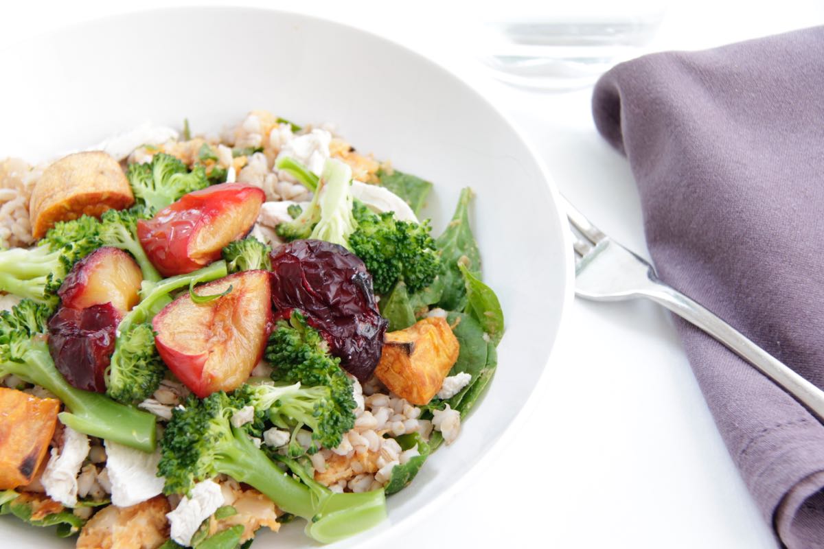 Warm salad with poached chicken, barley, roast pumpkin, greens and plum