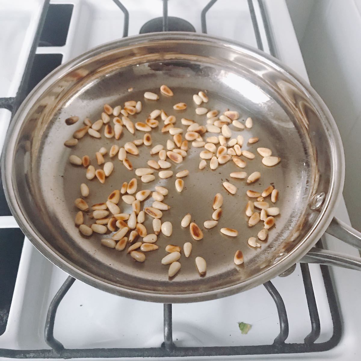 My first step is always to toast the pine nuts. I try to do this as a single task, e.g. not multi-tasking as they seem to go from uncooked to burnt very quickly and need constant watching.
