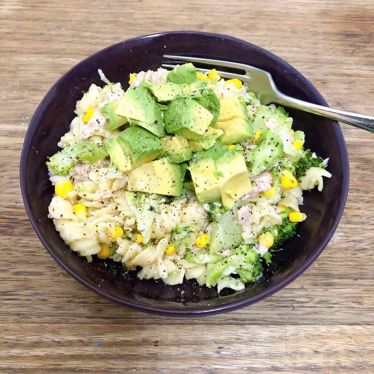 Pasta with peas, corn & broccoli, topped with avocado