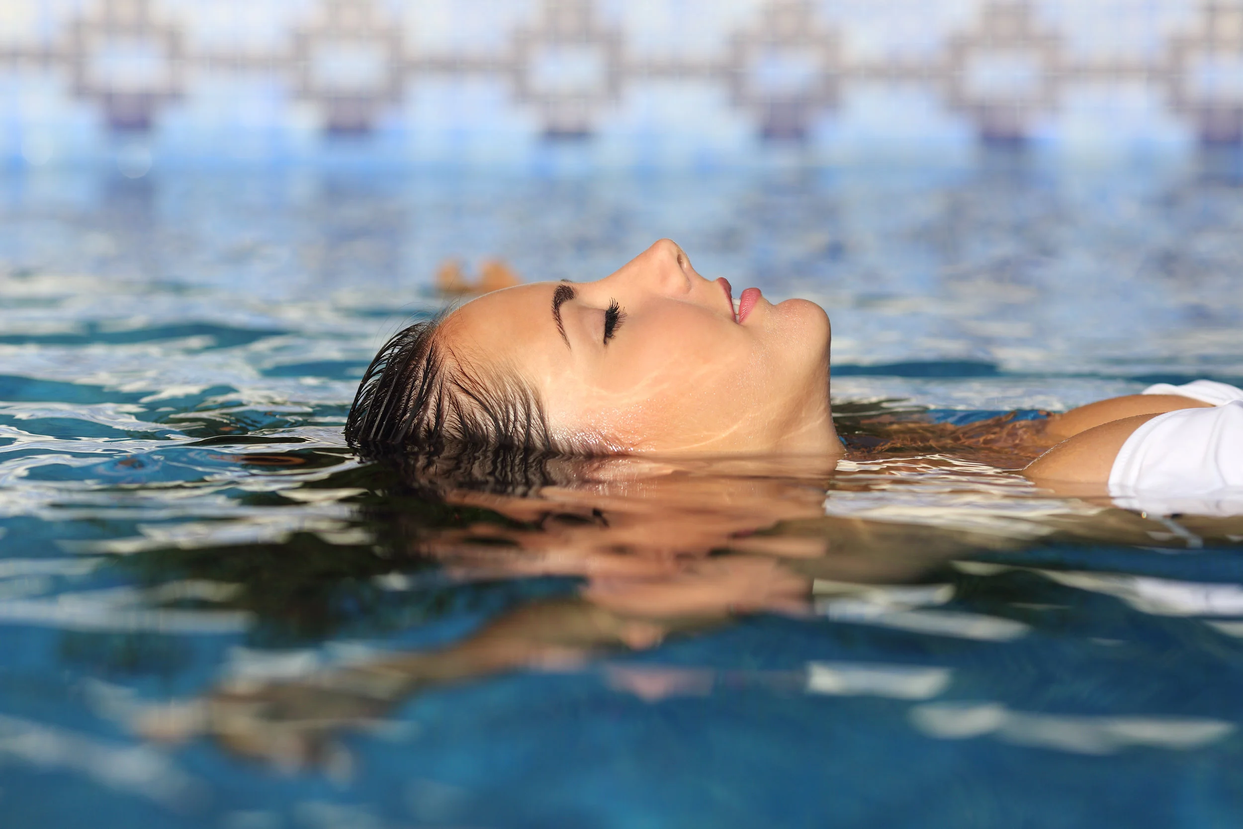 Profile of a beauty relaxed woman face floating in water.jpg
