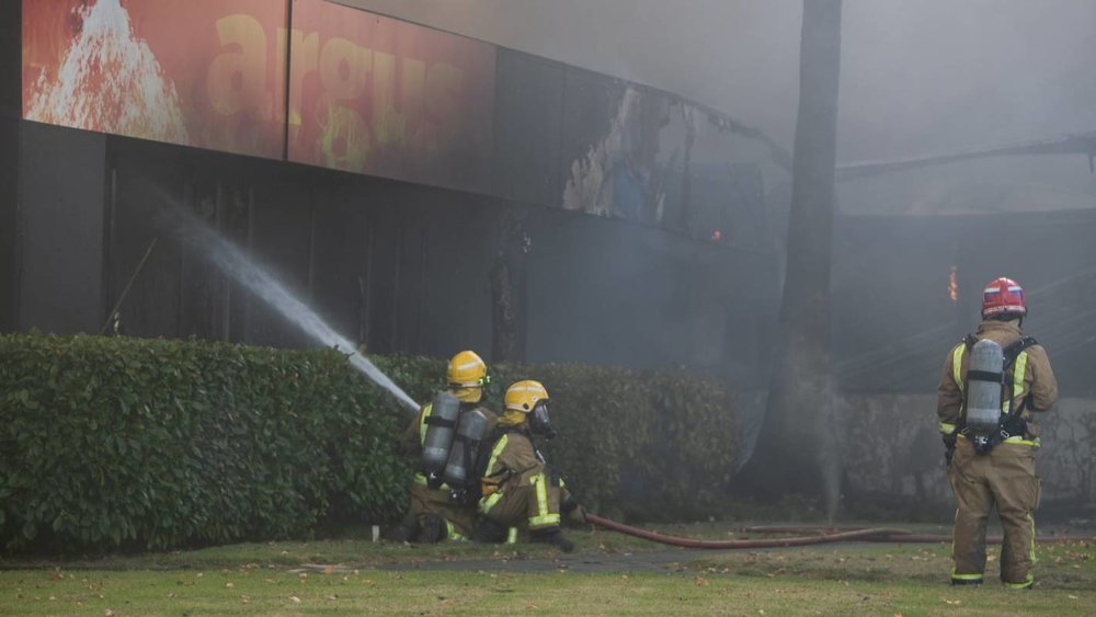  Flames could be seen coming from the roof of the Argus building.  CHRIS MCKEEN/STUFF  