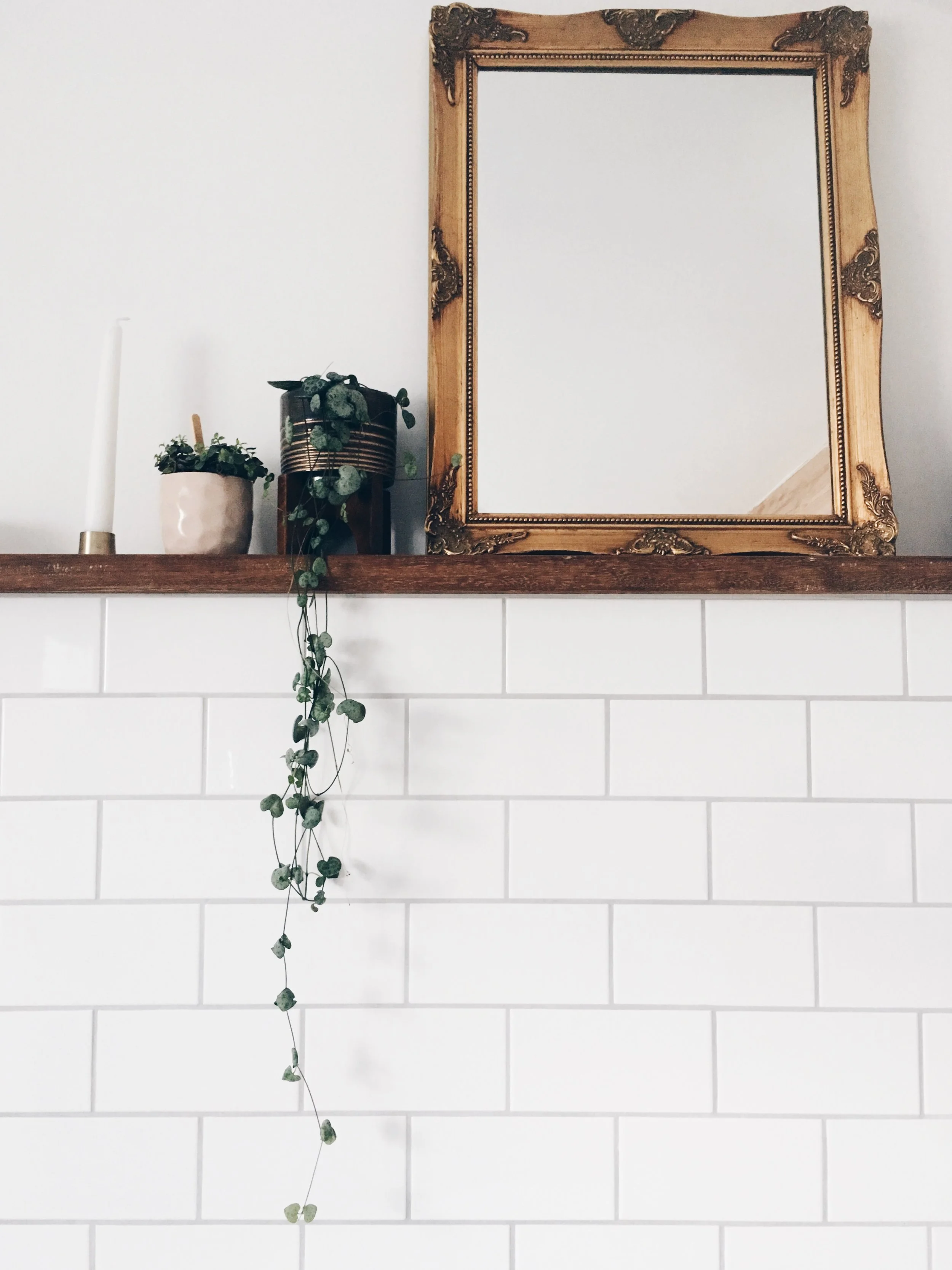 The wood used for the shelf, steps and window sill is all reclaimed iroko from school lab benches. It adds an old touch amongst all of the new details. The vintage mirror was an eBay find, the planter is from West Elm, the pink potted plant is from The People Shop and the candle holder is from Hus and Hem. 