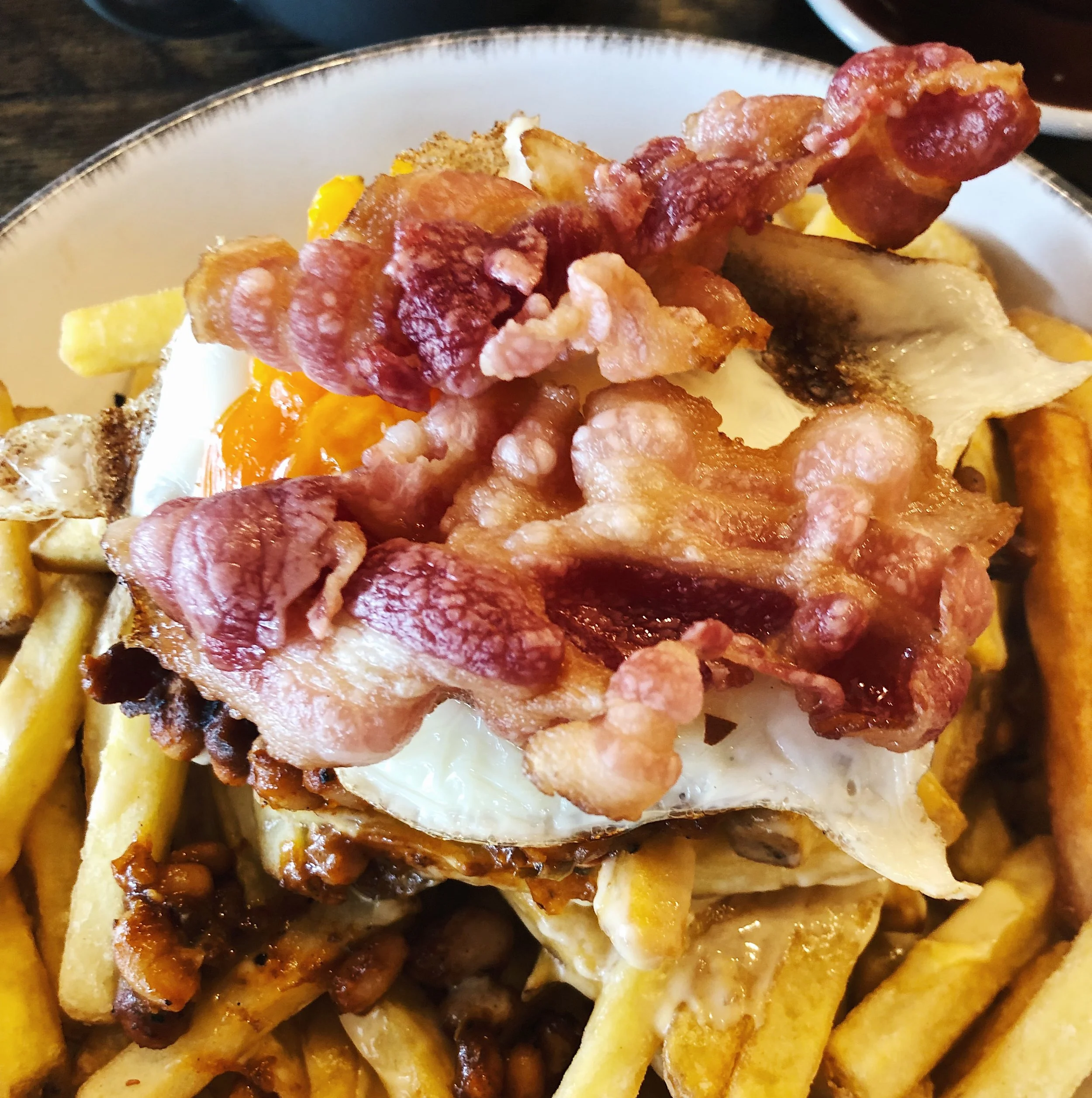 This breakfast was so good!! Smoky barbecue beans and cheese sauce on fried potatoes topped with fried egg and bacon. It was huge and my husband had to help me finish it (doesn’t often happen). Very filling for a rainy morning.
