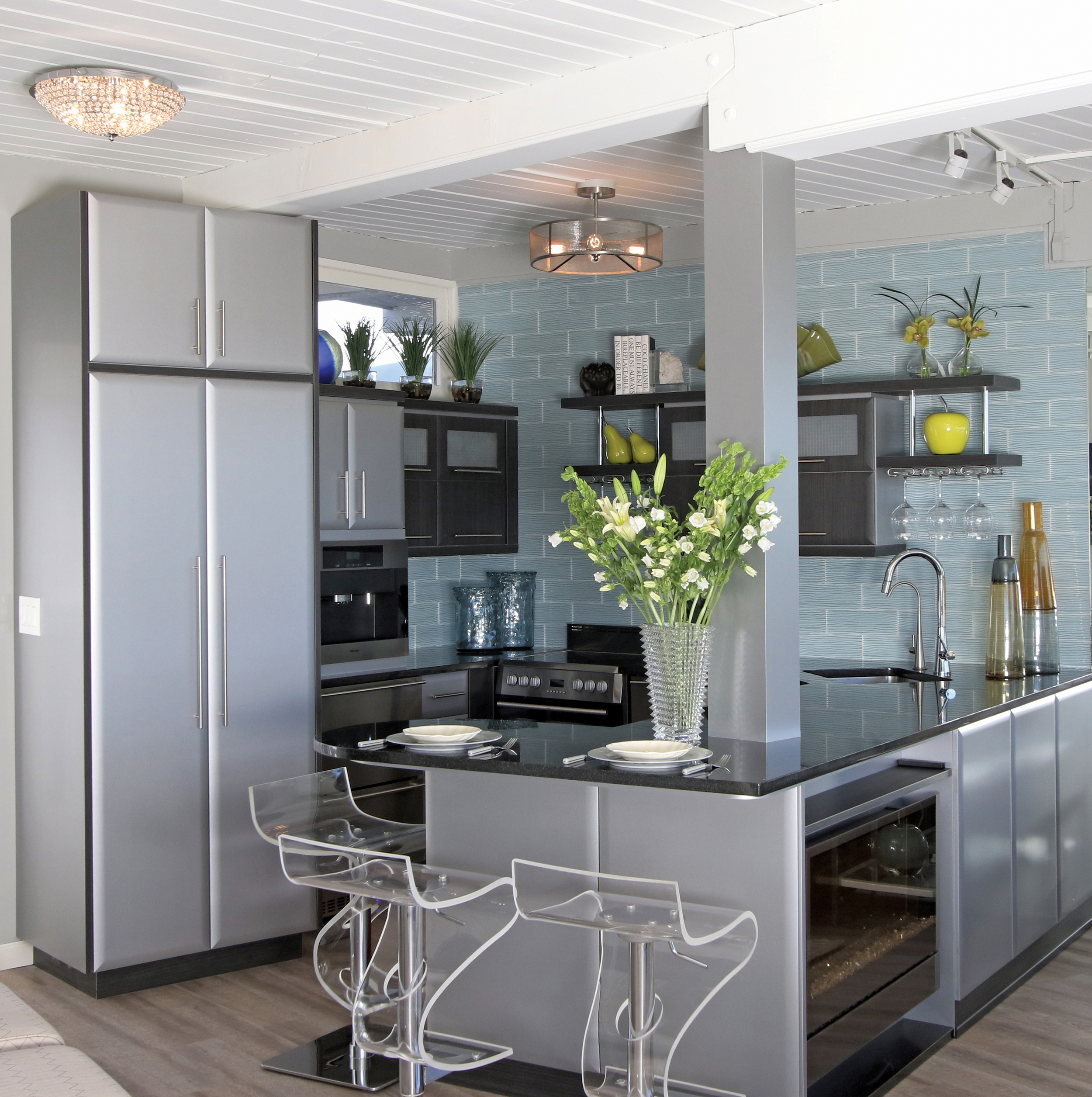 By removing original wall and closet, the kitchen area now becomes a bar serving destination as well.