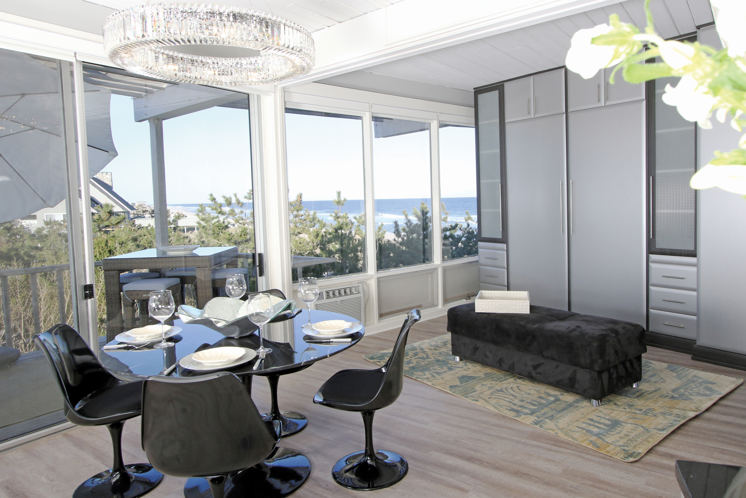 When dining with an ocean view, one would never suspect that a Murphy closet bed system is hiding in the adjacent wall.