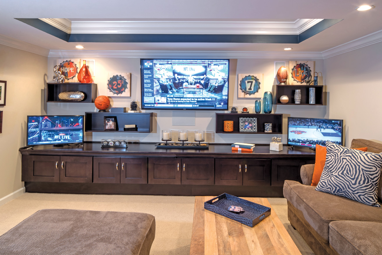 Ultimate custom multi-media room lets family and friends enjoy their sporting events in luxury with a side game of shuffleboard. 
