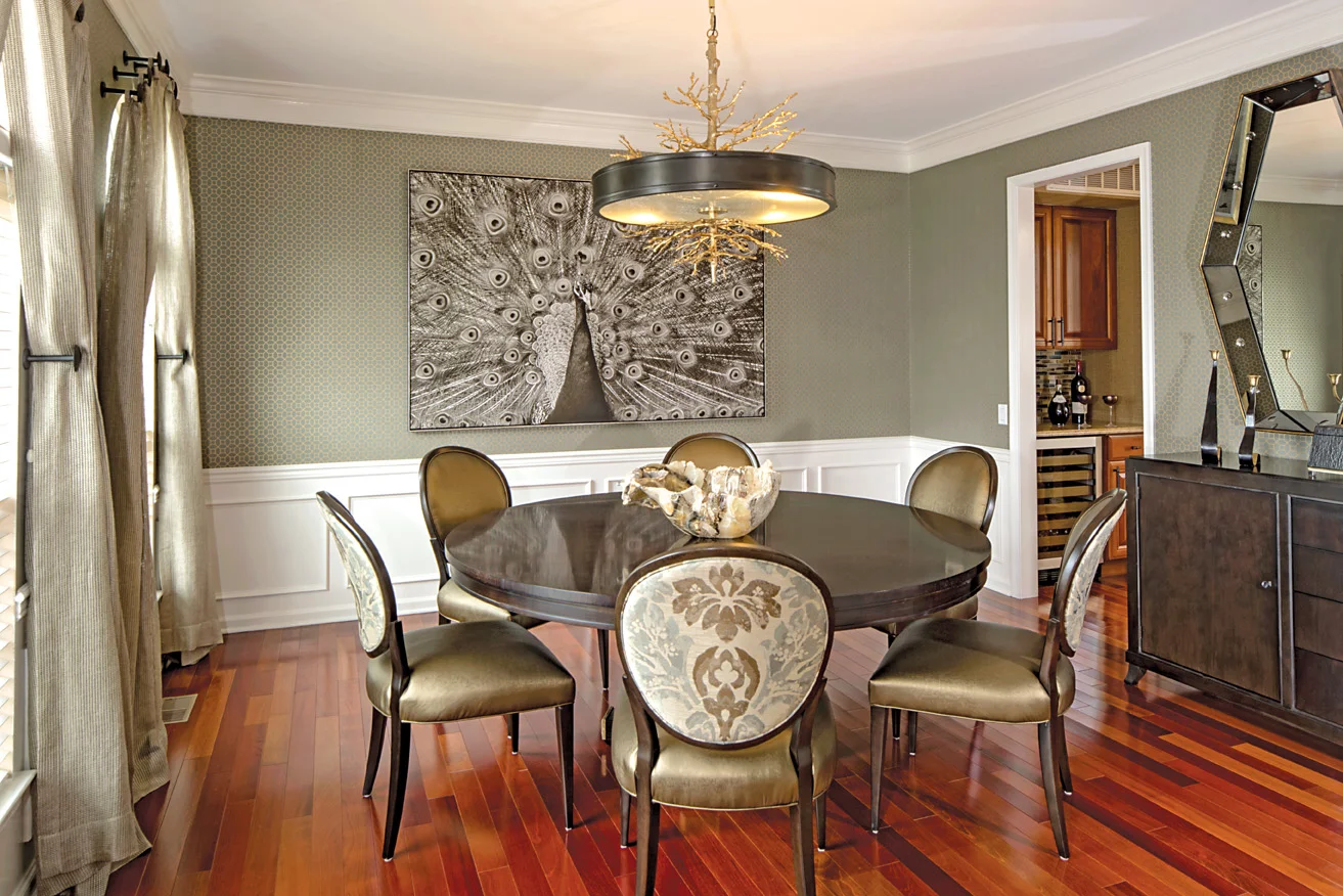 Elegant and welcoming dining room. Textured wallcovering coordinates with metallic leather chair seats; perfect for practical living with style.