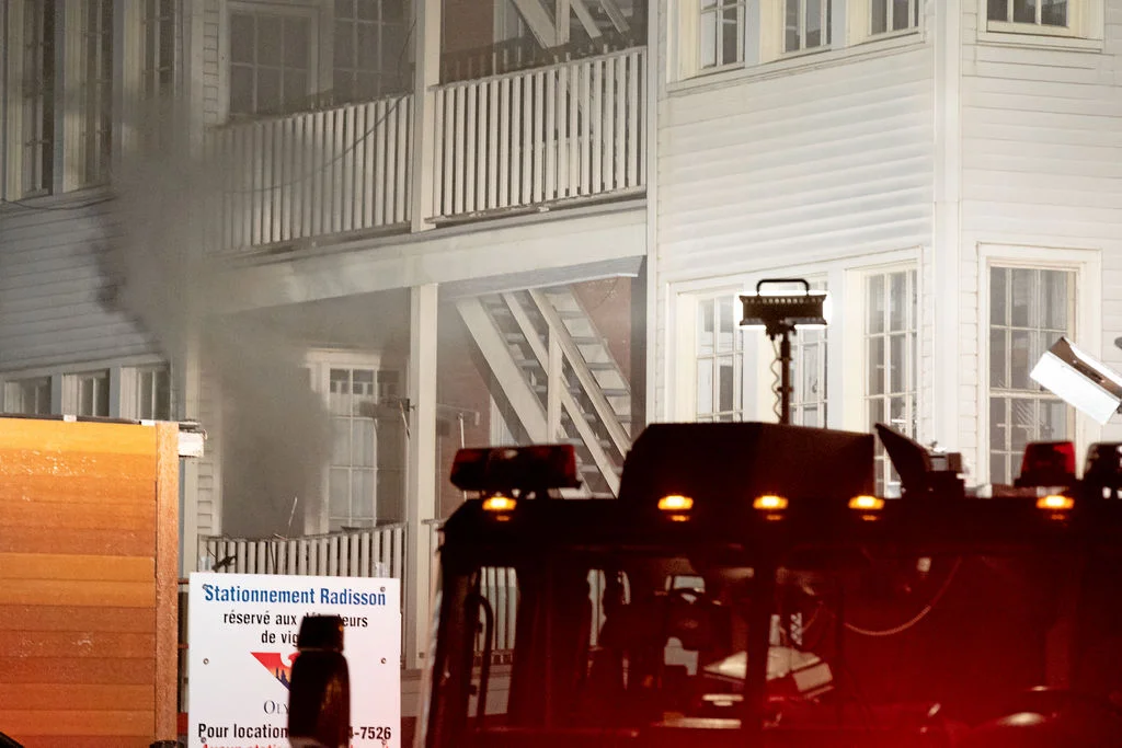 A view of the back of the building. Our apartment is on the right. Smoke escapes from the apartment on the left, which is on our floor, across the hall, and the only other apartment aside from the source apartment to suffer extensive damage.