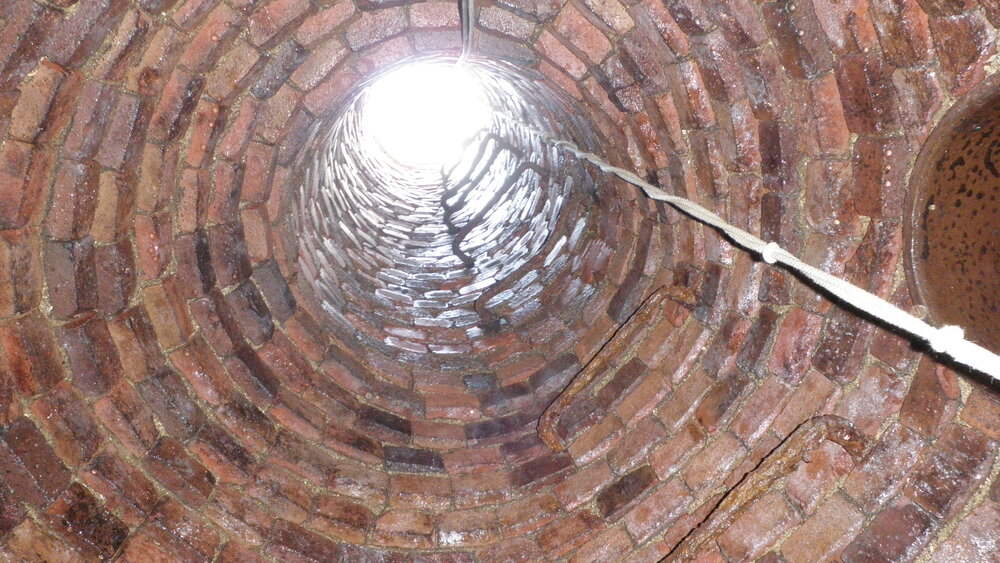  A view looking up from the bottom of a manhole. 