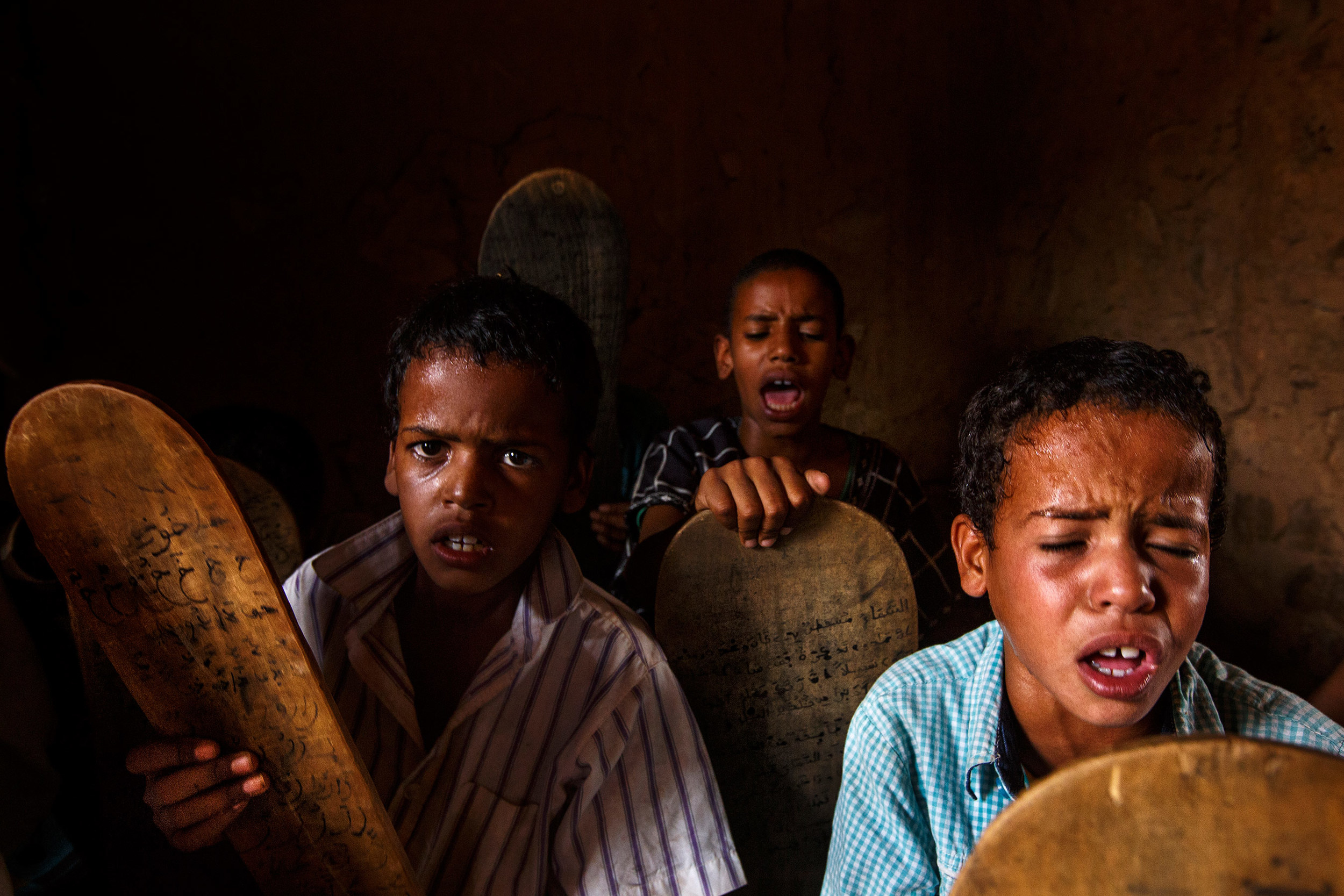 Mauritania,-Adrar---Children-reading-off-of-tablets-and-praying-in-a-Mahadara---traditional-Islamic-school.jpg