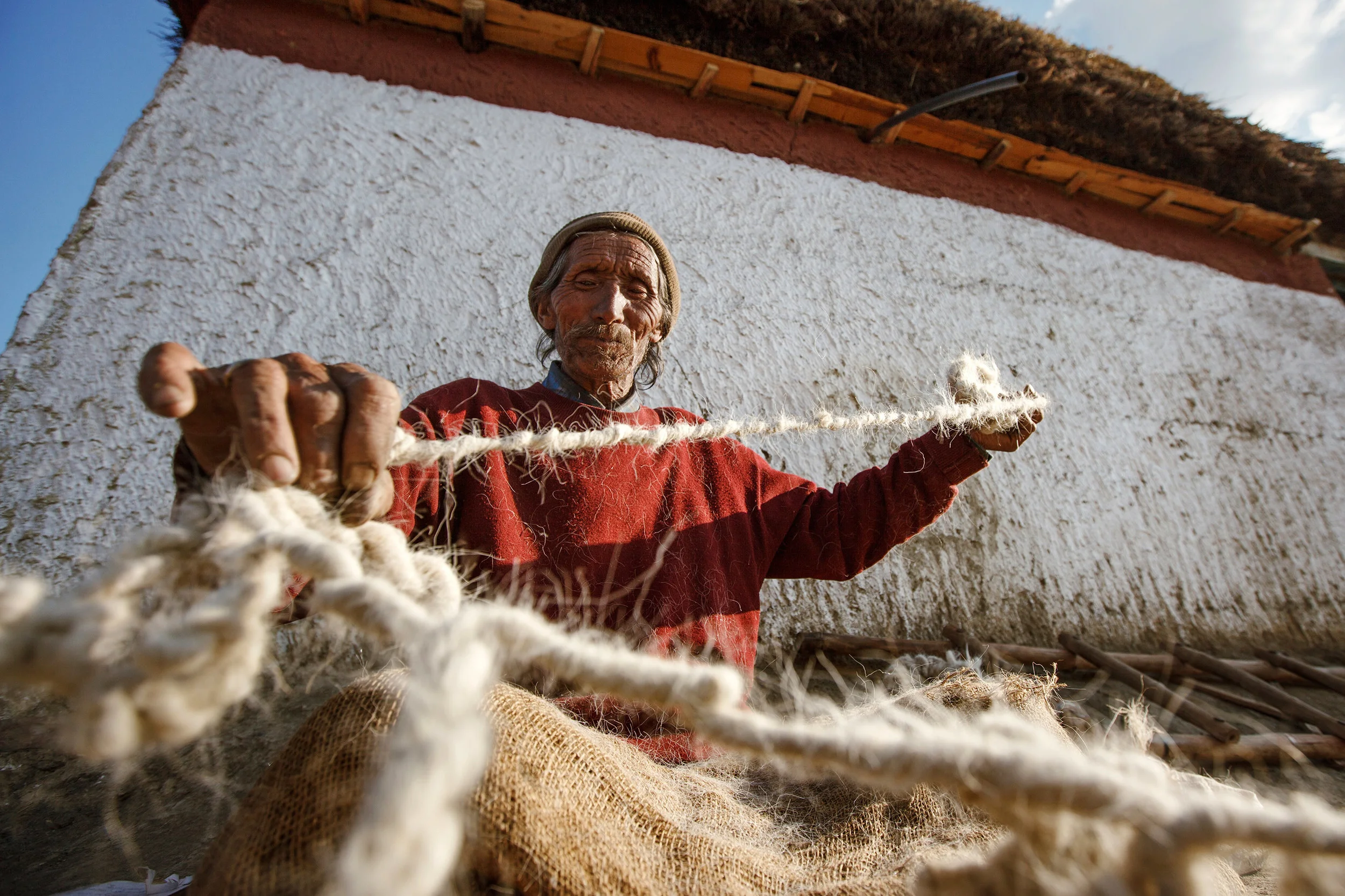 Man-with-wool-threads,-Hikkim,-Spiti-Valley,-India.jpg