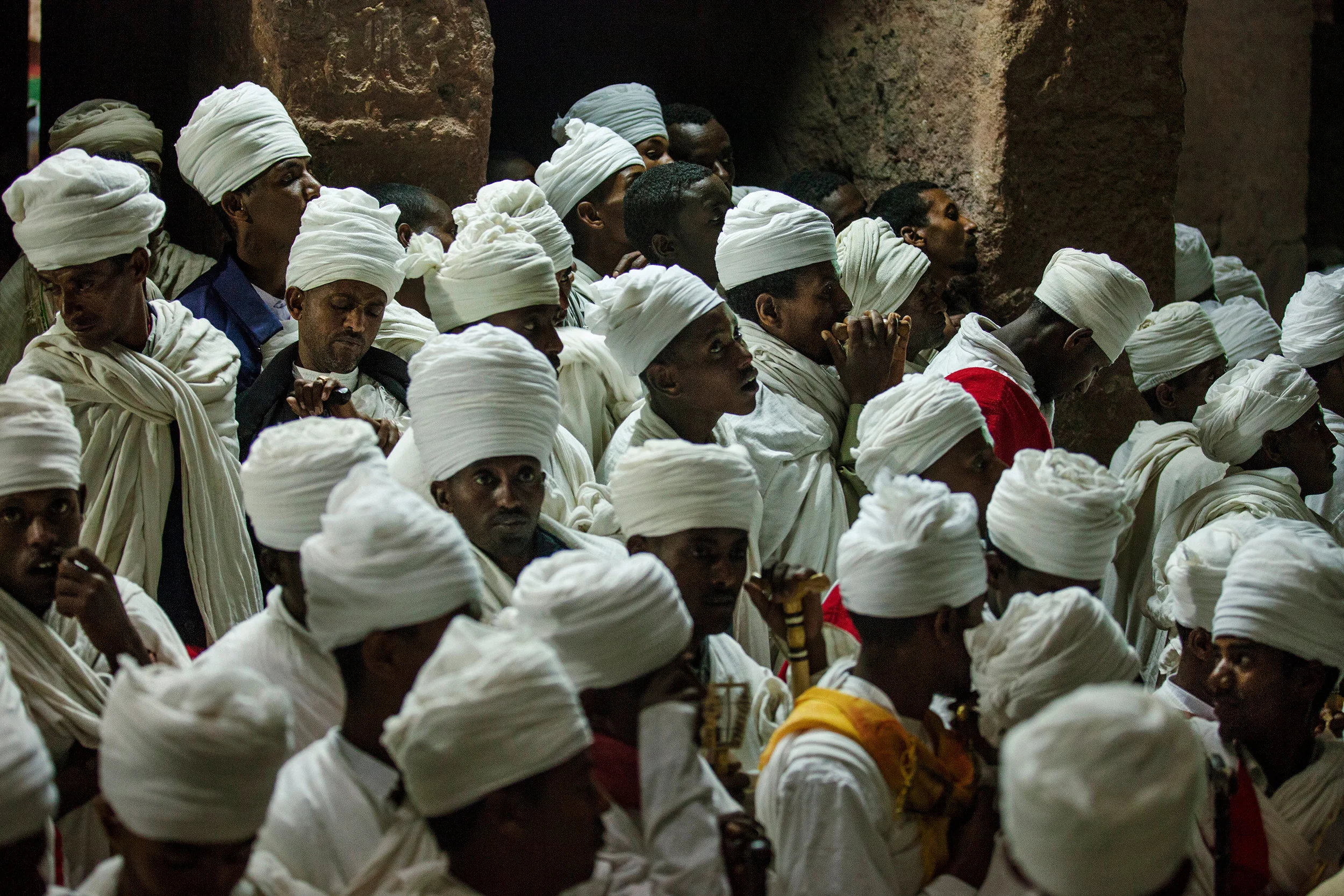 A-group-of-deacons-by-a-rock-church-during-the-final-celebrations-in-Lalibela,-Ethiopia.jpg