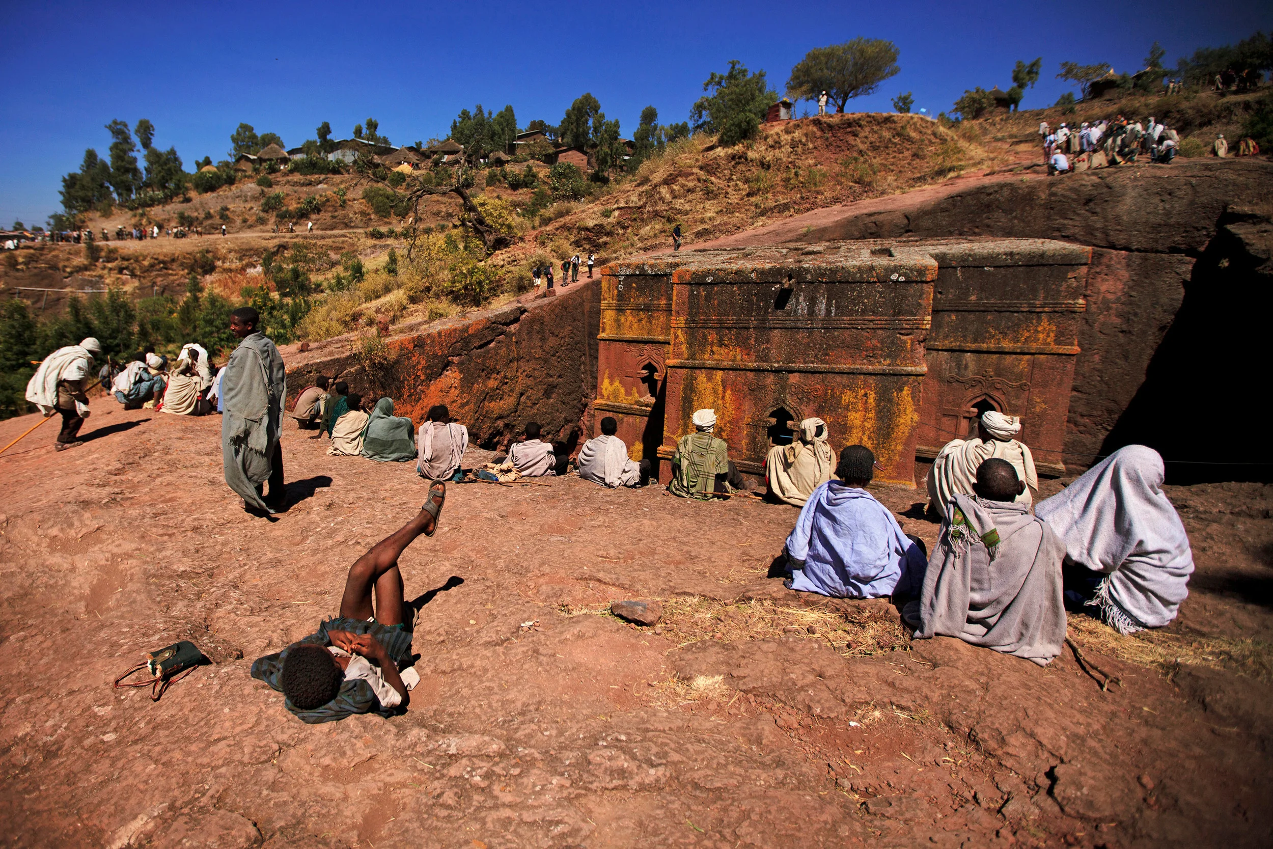 Pilgrims-relaxing-above-the-church-of-Saint-George,-Lalibela,-Ethiopia.jpg