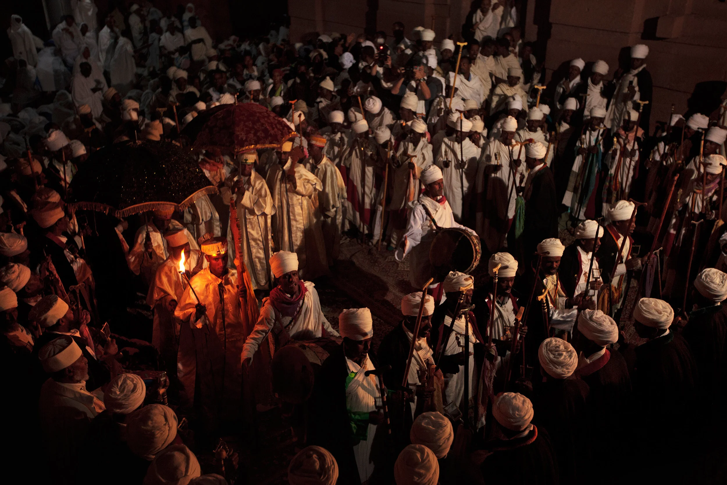 Deacons-walk-with-a-flame-in-a-procession-during-Christmas-celebrations,-Lalibela,-Ethiopia.jpg