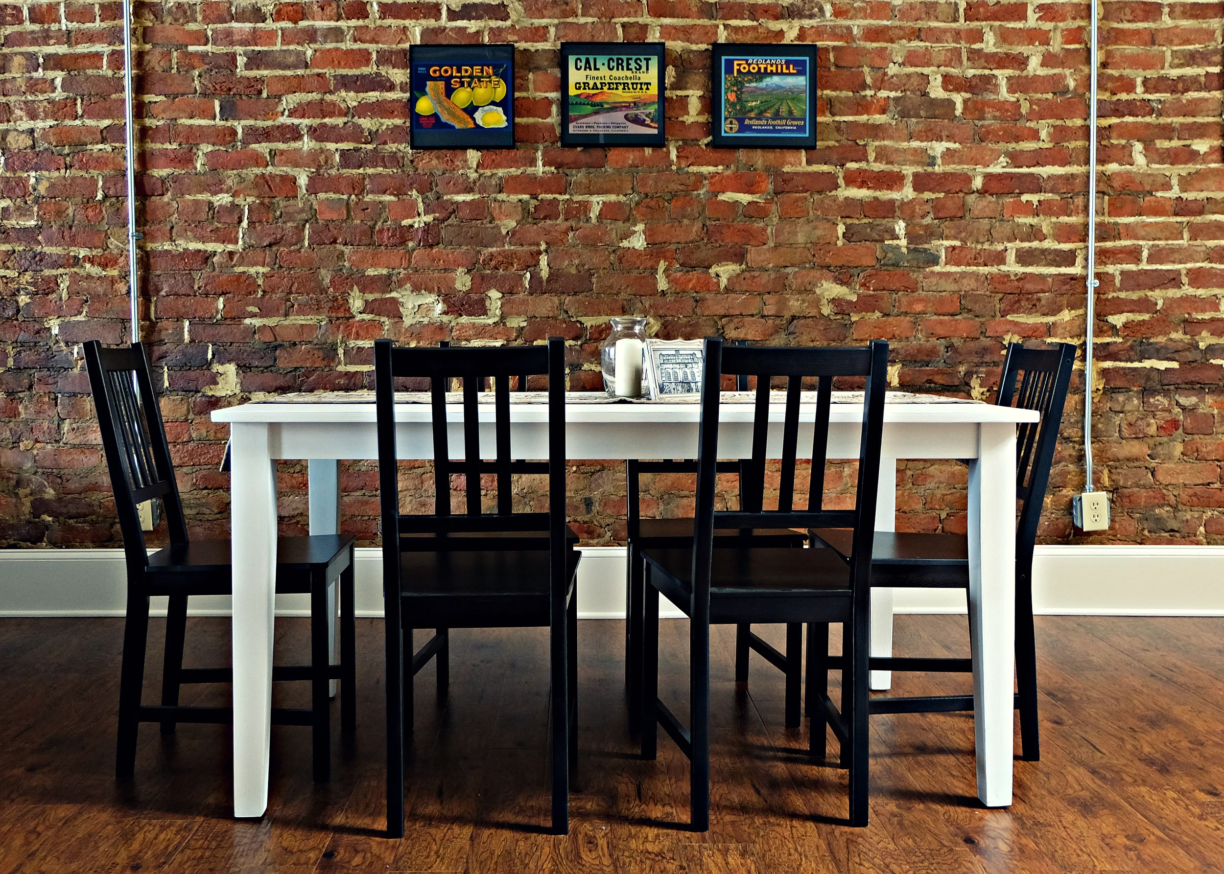 Dining Room Table -- Refinished solid oak table. Paint is Annie Sloan Chalk Paint in Pure. Dining Room Chairs -- Stefan chair in black-brown. Wall Art -- Vintage Orange Labels from the California Citrus State Historic Park