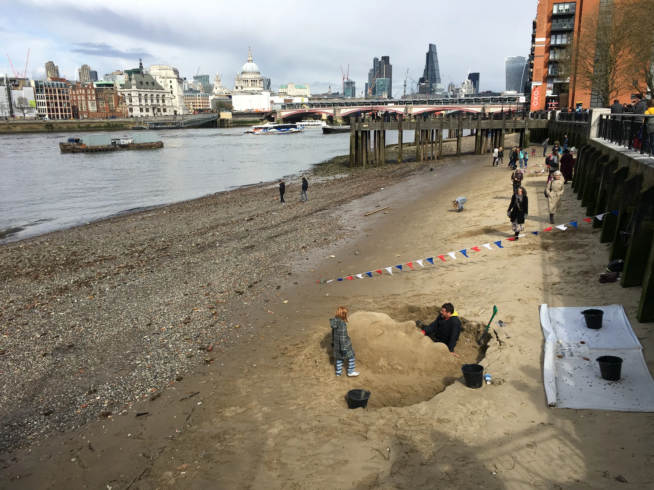Face sculpture in the sand