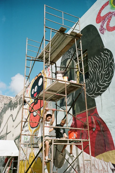 BASIK on the right with GOLA climbing the scaffold in Wynwood.