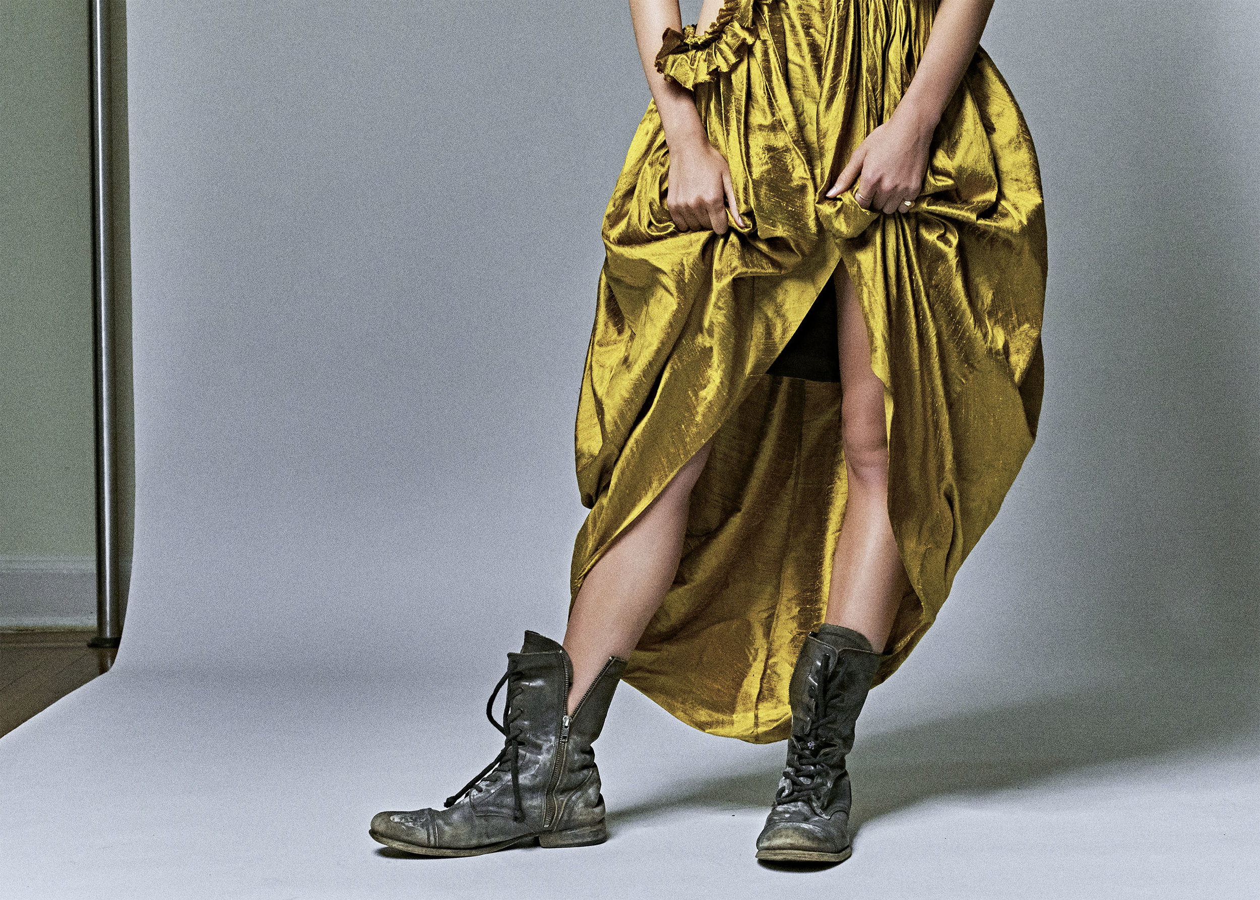 kelsey randall model gold yellow citrine raw silk shantung asymmetrical ruffle sleeve side cut out gathered ruffled flounce long gown high-low hem tulip high neck dress black leather combat boots