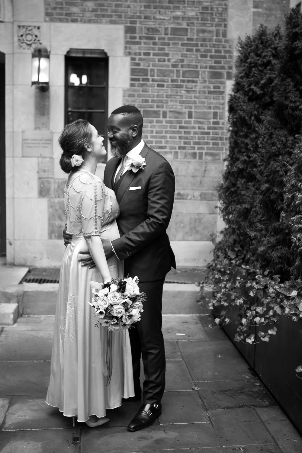 The bride and groom pose outside the Upper West Side Wedding Venue. | Upper West Side Intimate Wedding | Kate & Sylvester's wedding in Manhattan.