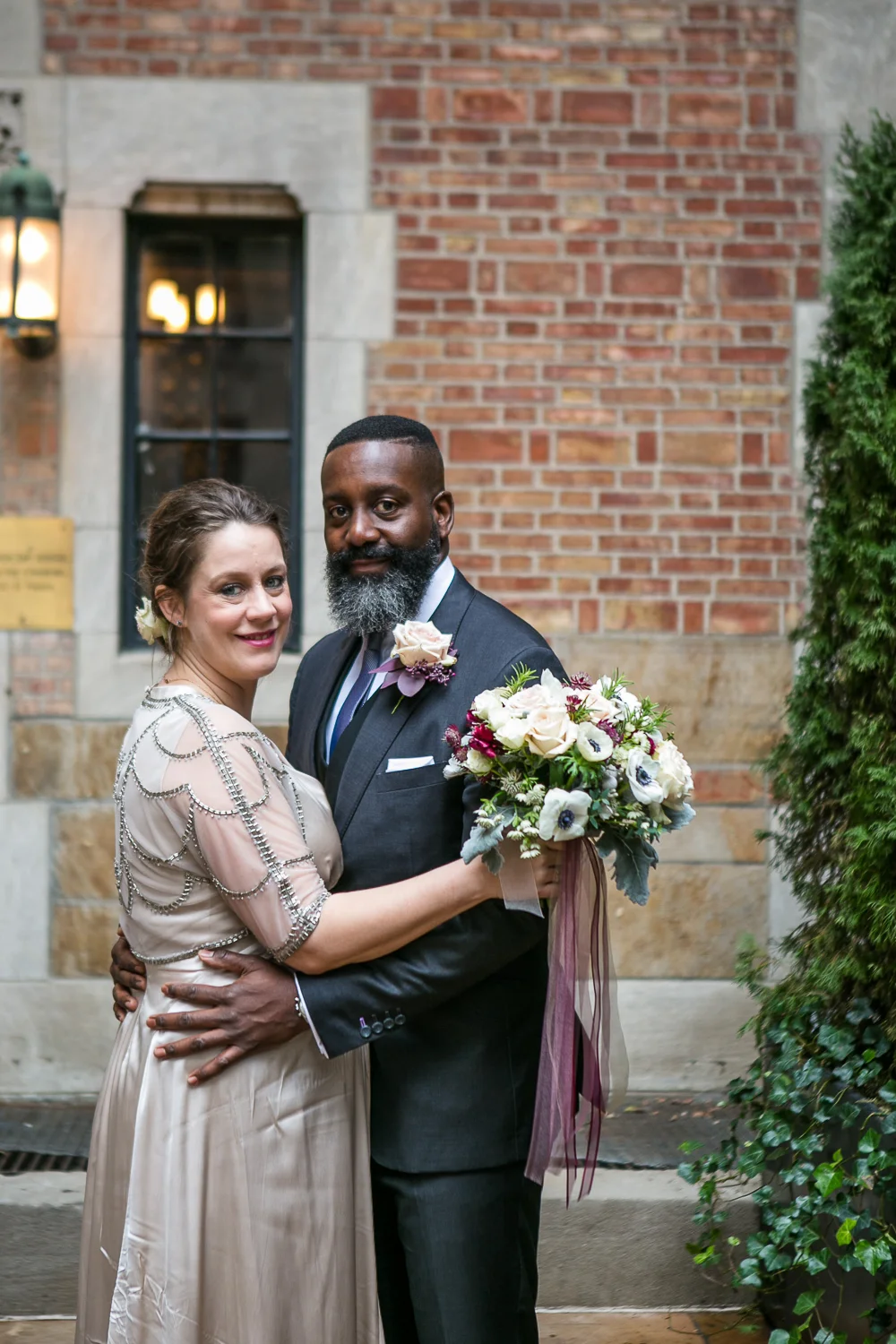 The bride and groom pose outside the Upper West Side Wedding Venue. | Upper West Side Intimate Wedding | Kate & Sylvester's wedding in Manhattan.