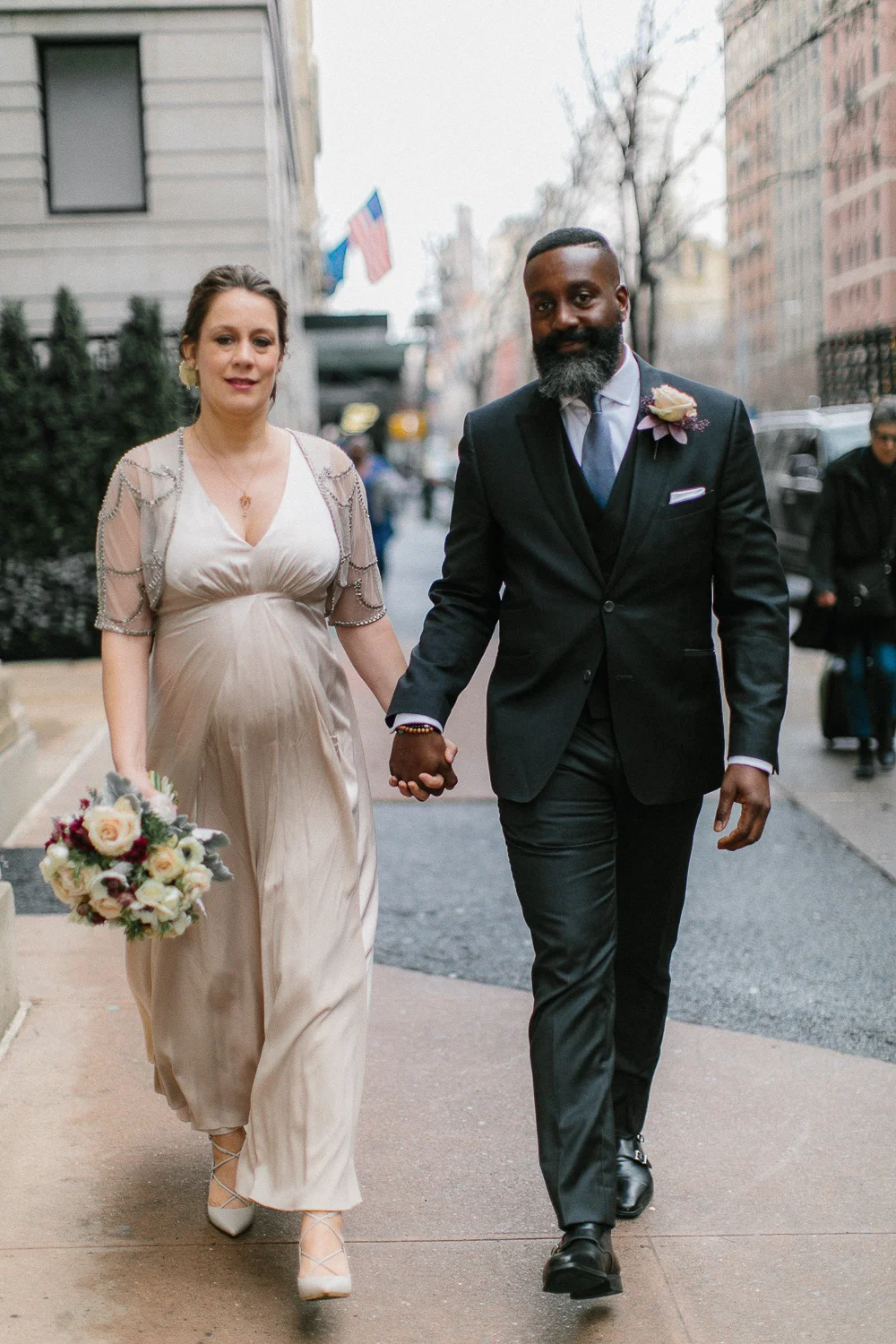 The bride and groom walk down the street outside the Upper West Side Wedding Venue. | Upper West Side Intimate Wedding | Kate & Sylvester's wedding in Manhattan.