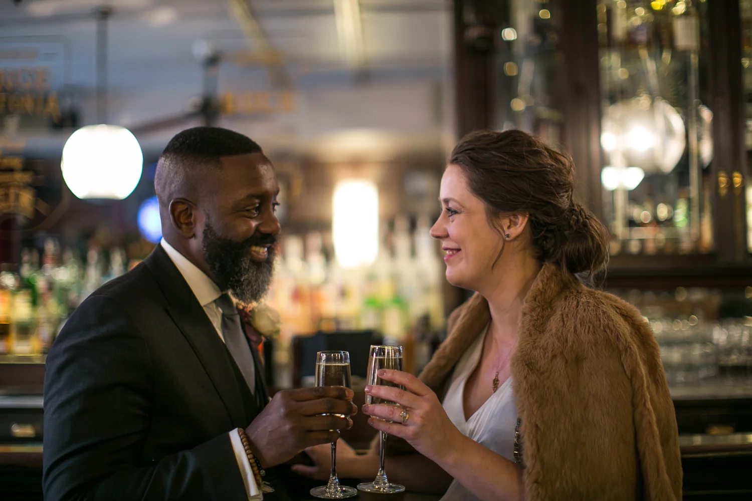 Portrait of a bride and groom toasting with champagne at their intimate restaurant wedding venue in Manhattan. | Upper West Side Intimate Wedding | Kate & Sylvester's wedding in Manhattan.