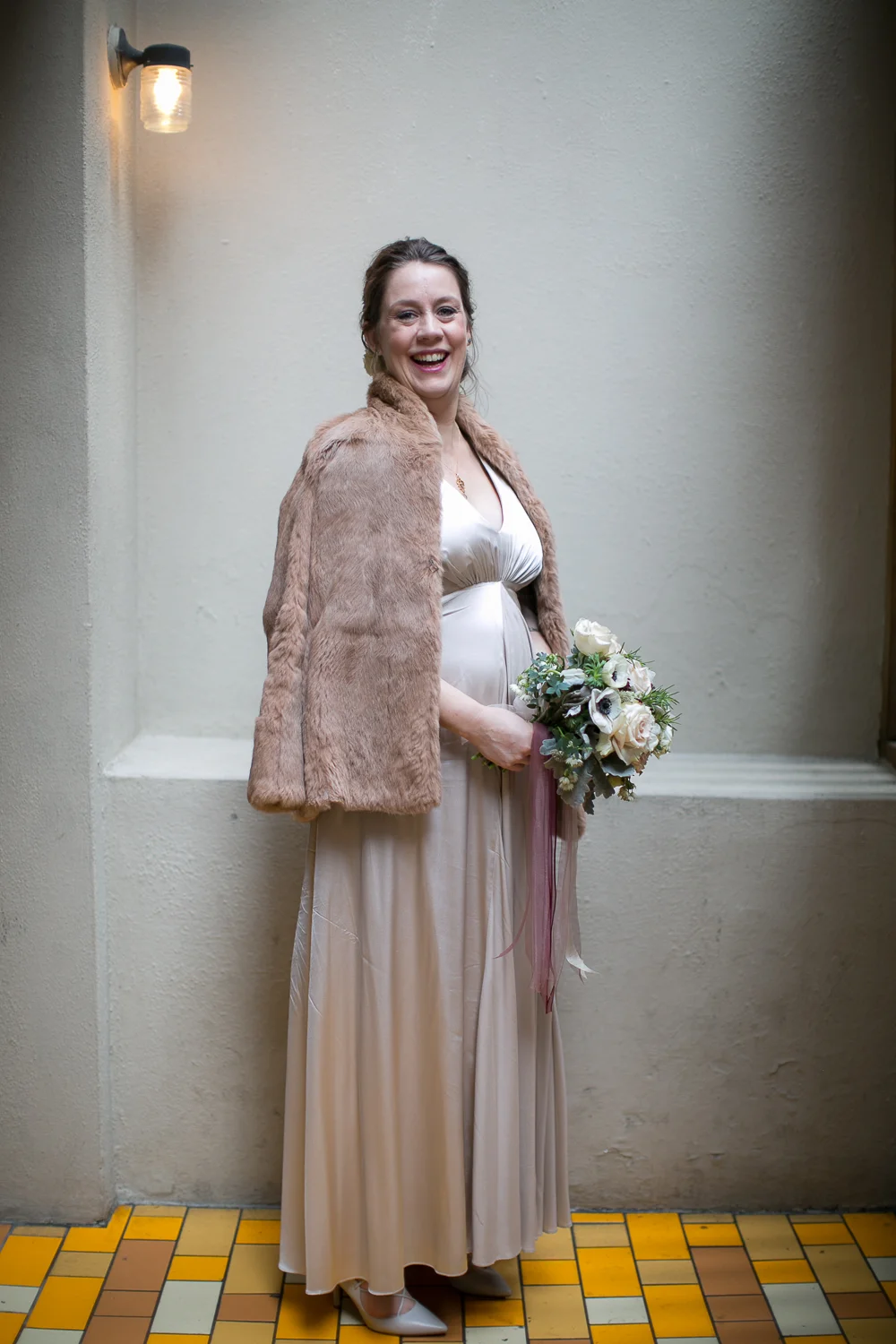Portrait of the bride wearing a blush dress and blush fur cape. | Upper West Side Intimate Wedding | Kate & Sylvester's wedding in Manhattan.