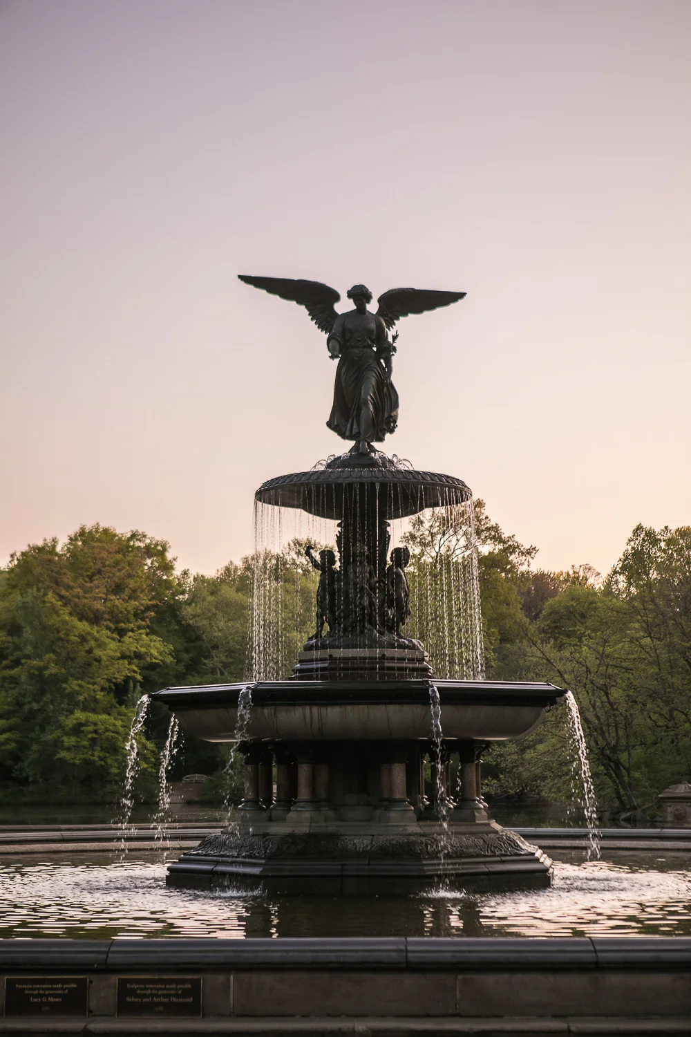Bride and groom taking wedding photos at Bethesda Fountain in Central Park. | Early Morning Sunrise Central Park Elopement in New York City.