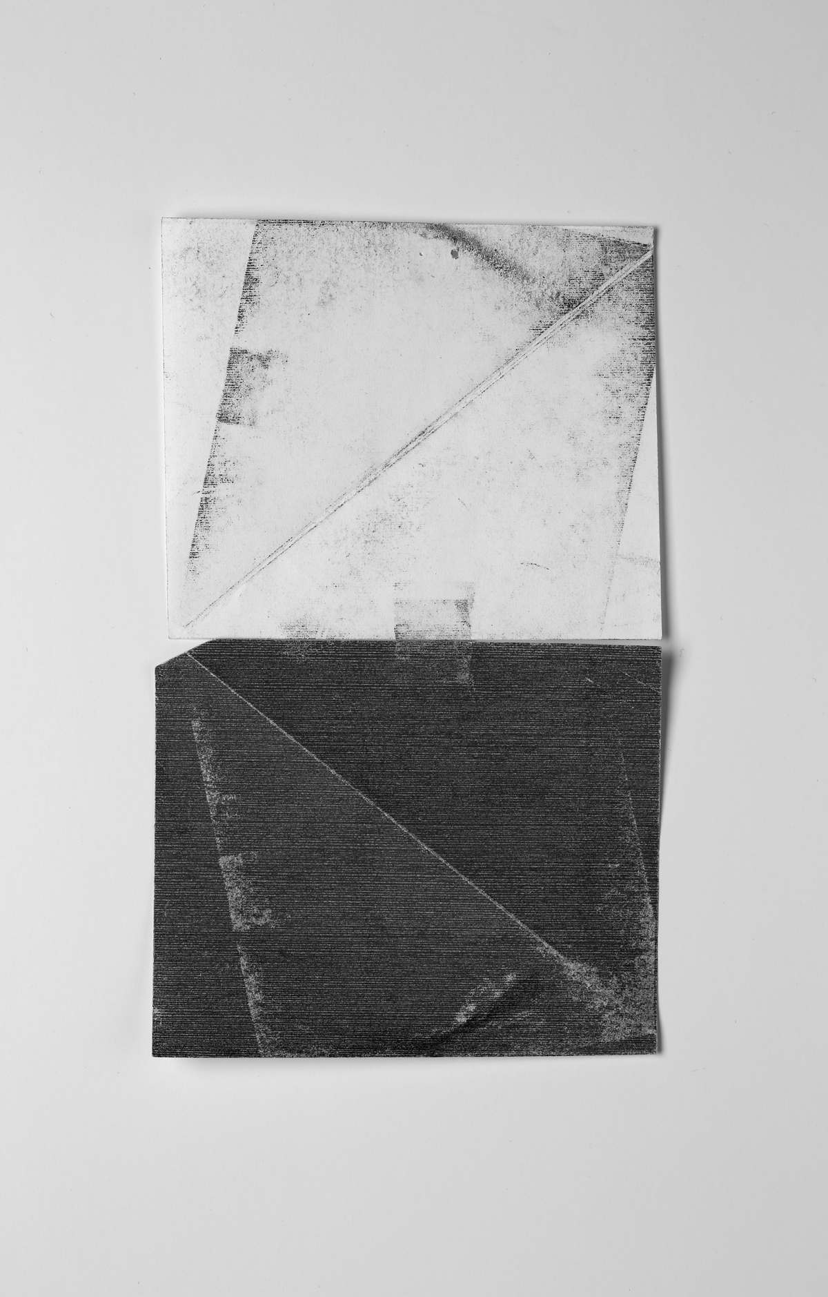   Untitled (test, from the ongoing series, Divided/Defined, Weights Measures and Emotional Geometry)   2013, pressed and folded transfer paper taped to regular bond paper, 11.5 x 9 inches 