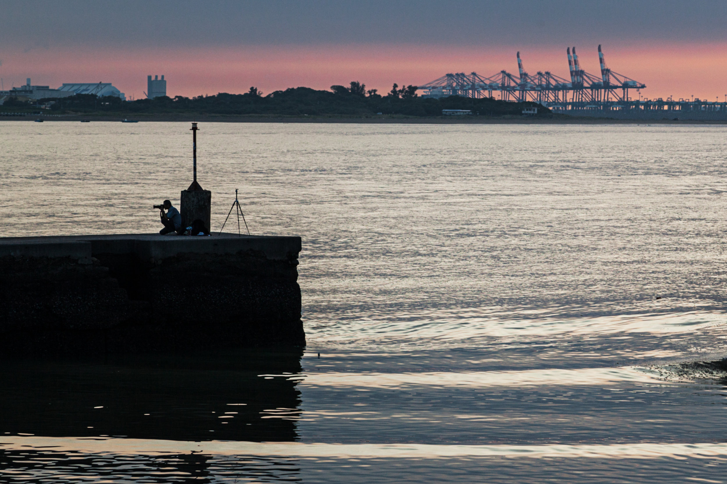 A photographer catches one of Tamsui's famous sunsets