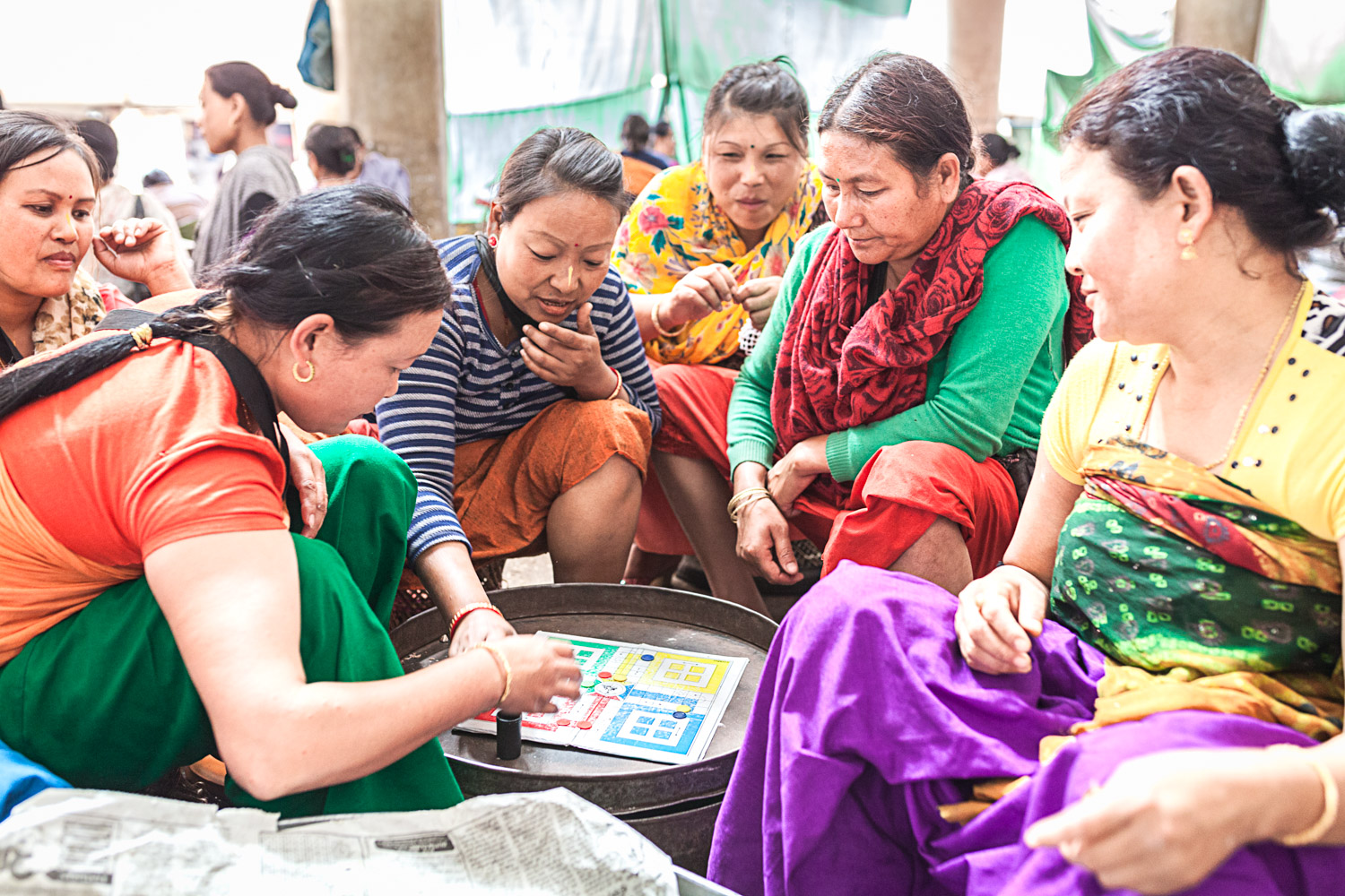A Nagaland State Transport bus took me south to Imphal, the state capital of Manipur. At Mother's Market, the world's largest female-only-run market, I met and chatted to these ladies playing Ludo.