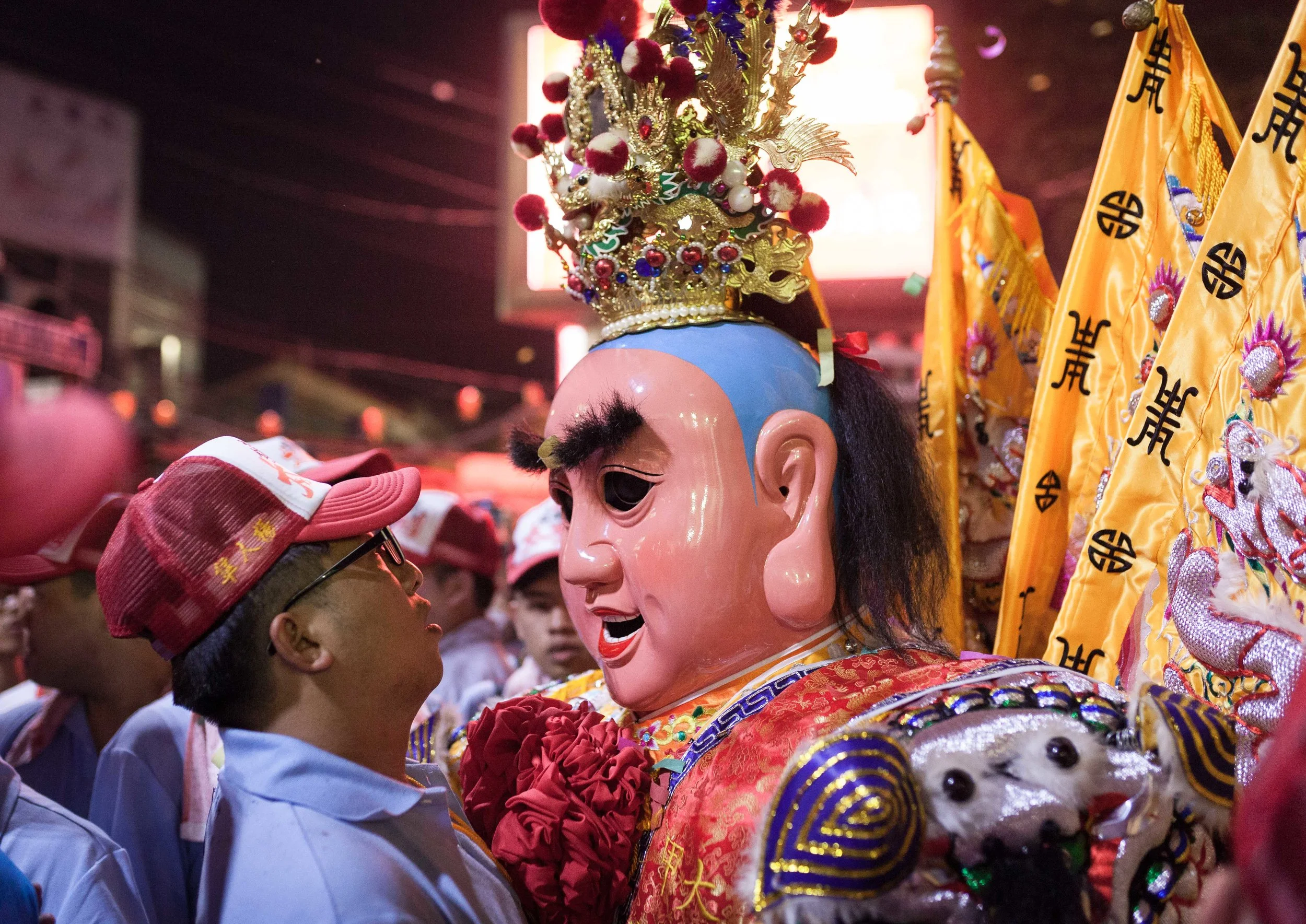 A man comes face to face with a Taiwanese god at the opening ceremony of the Dajia Mazu, the world's third largest religious pilgrimage -- Jenn Lann Temple, Taichung