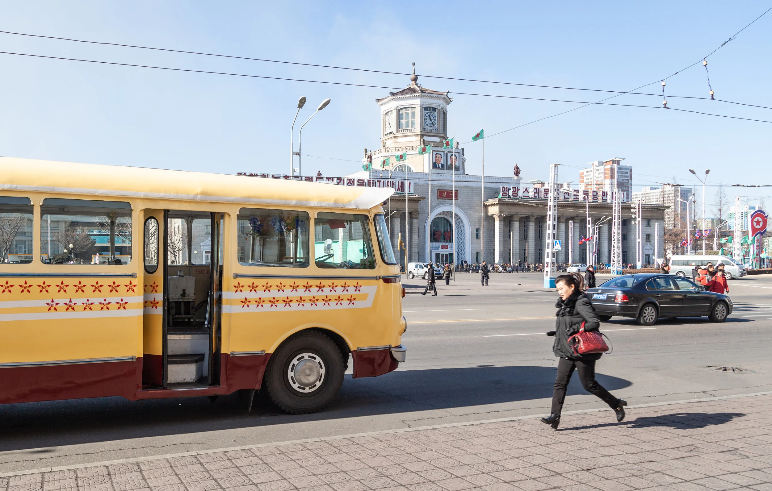 A lady runs for an appointment past an original 1960s trolleybus.