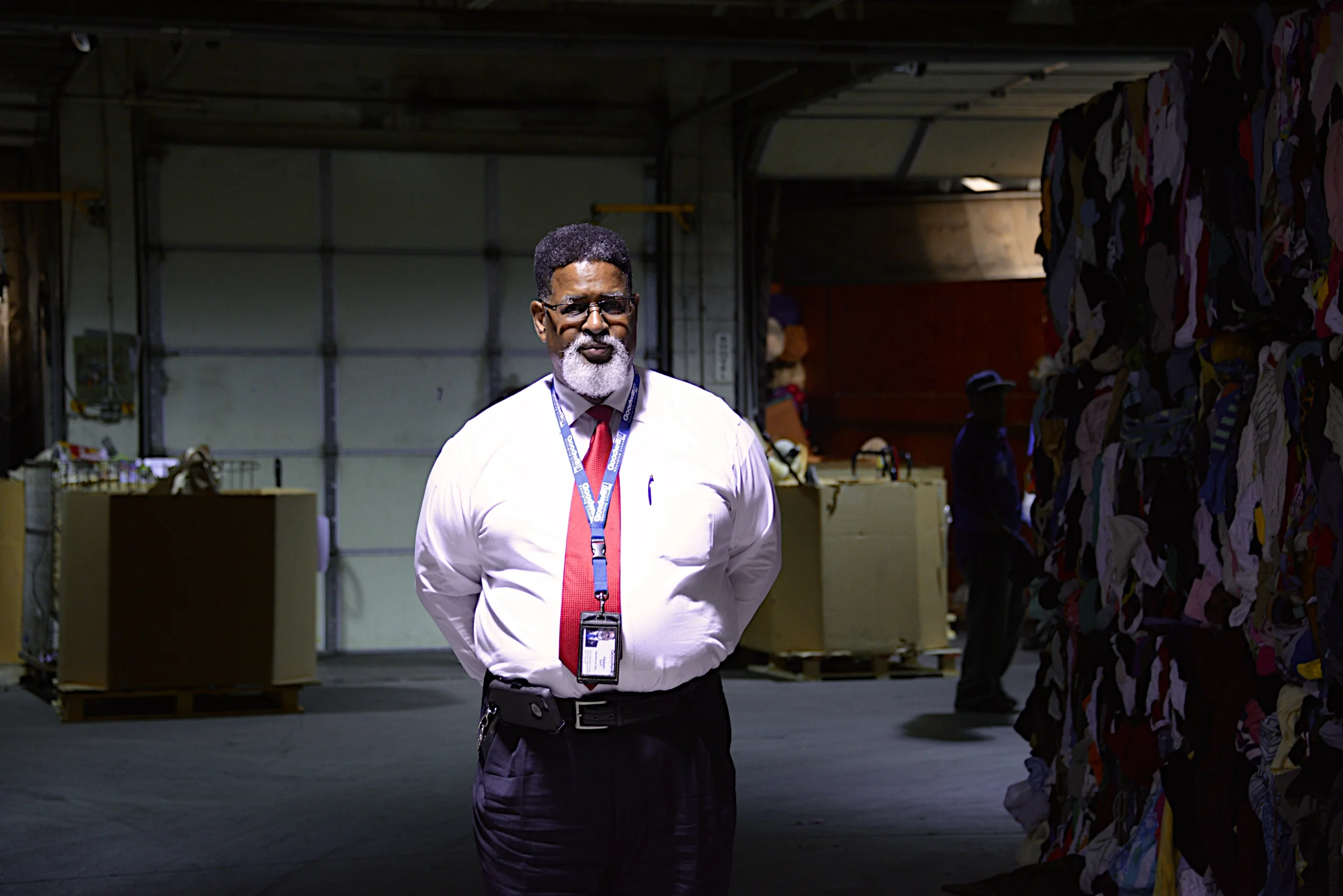 Photographed in the Goodwill donation warehouse. The sale of items supports Hasan's work.