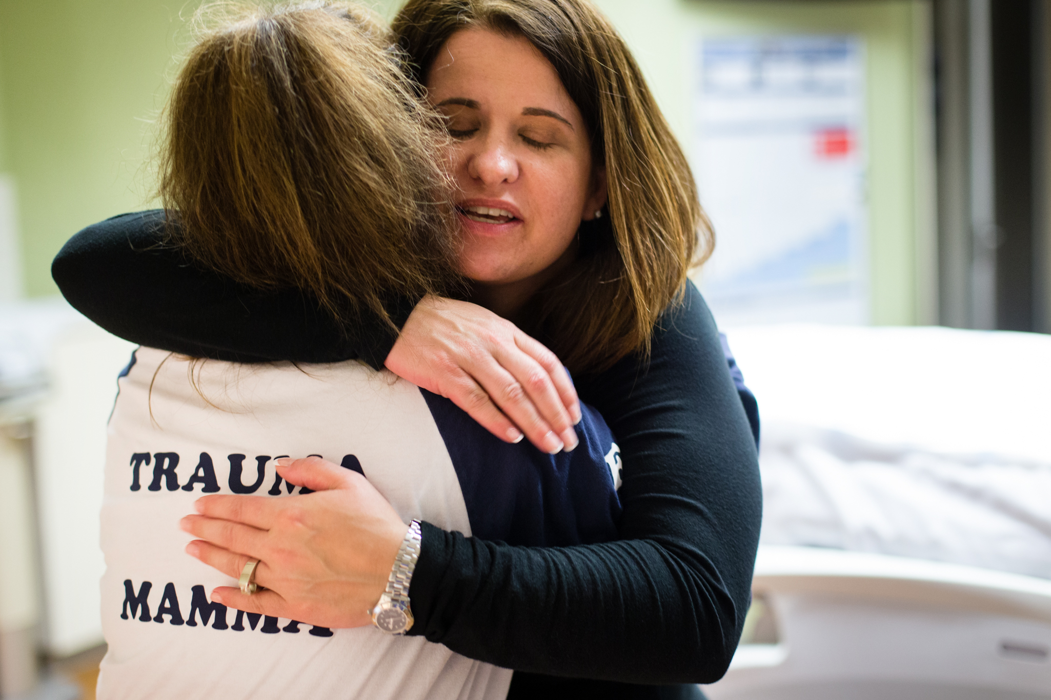 Parker hugs fellow nurse Karyn McComb whose shirt reads, Trauma Mamma .