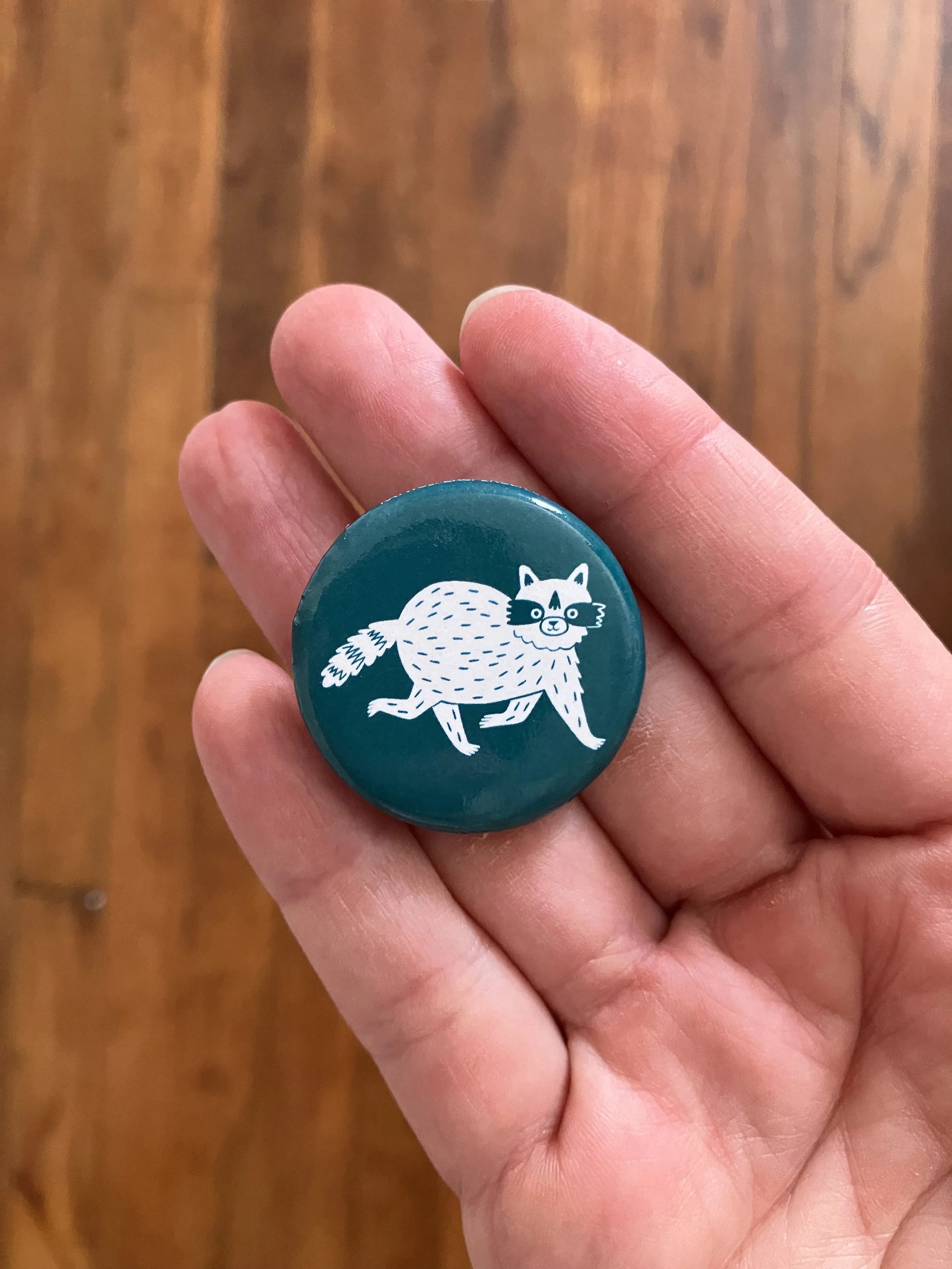 pin-back-button-raccoon-by-kay-wolfersperger.jpeg
