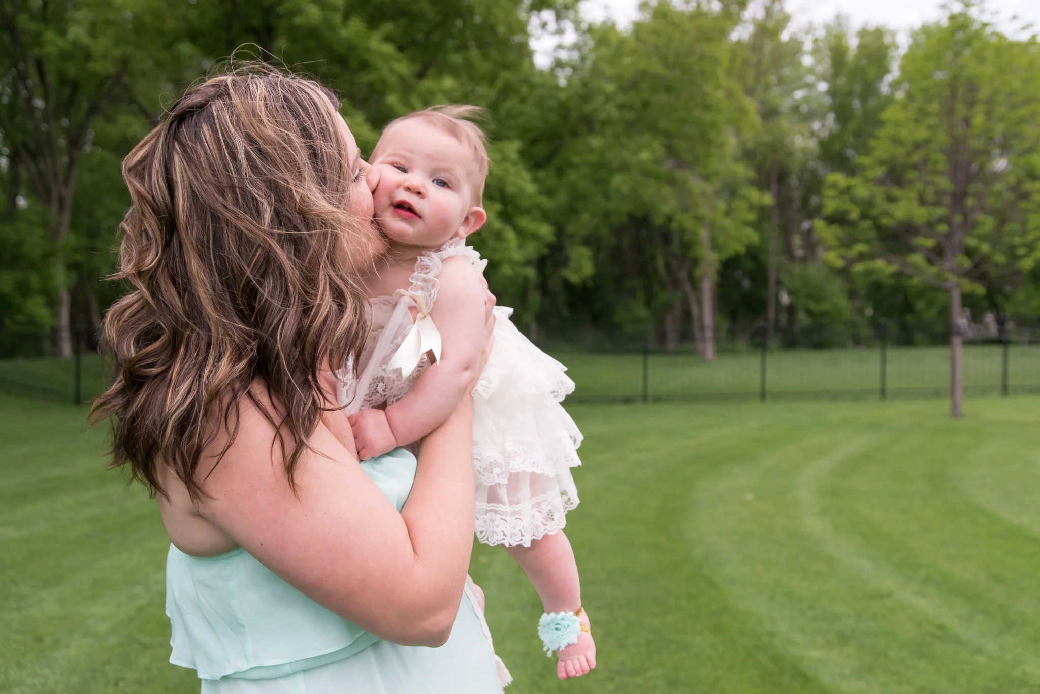 Mom kissing baby