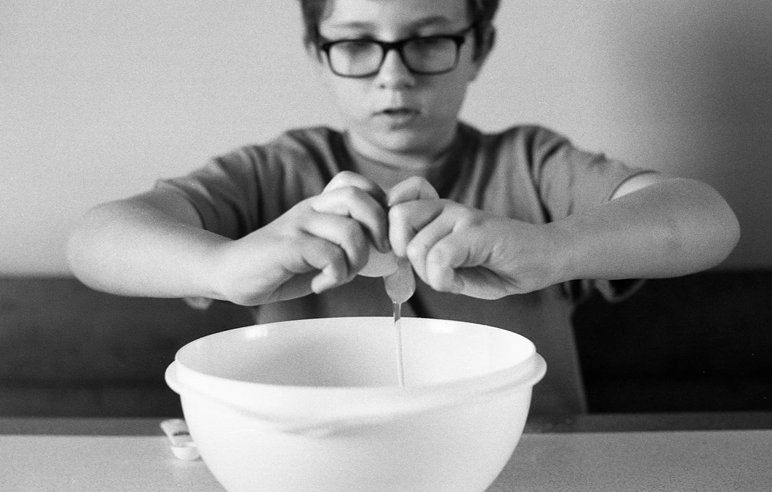 Boy cooking pumpkin mini muffins at home.