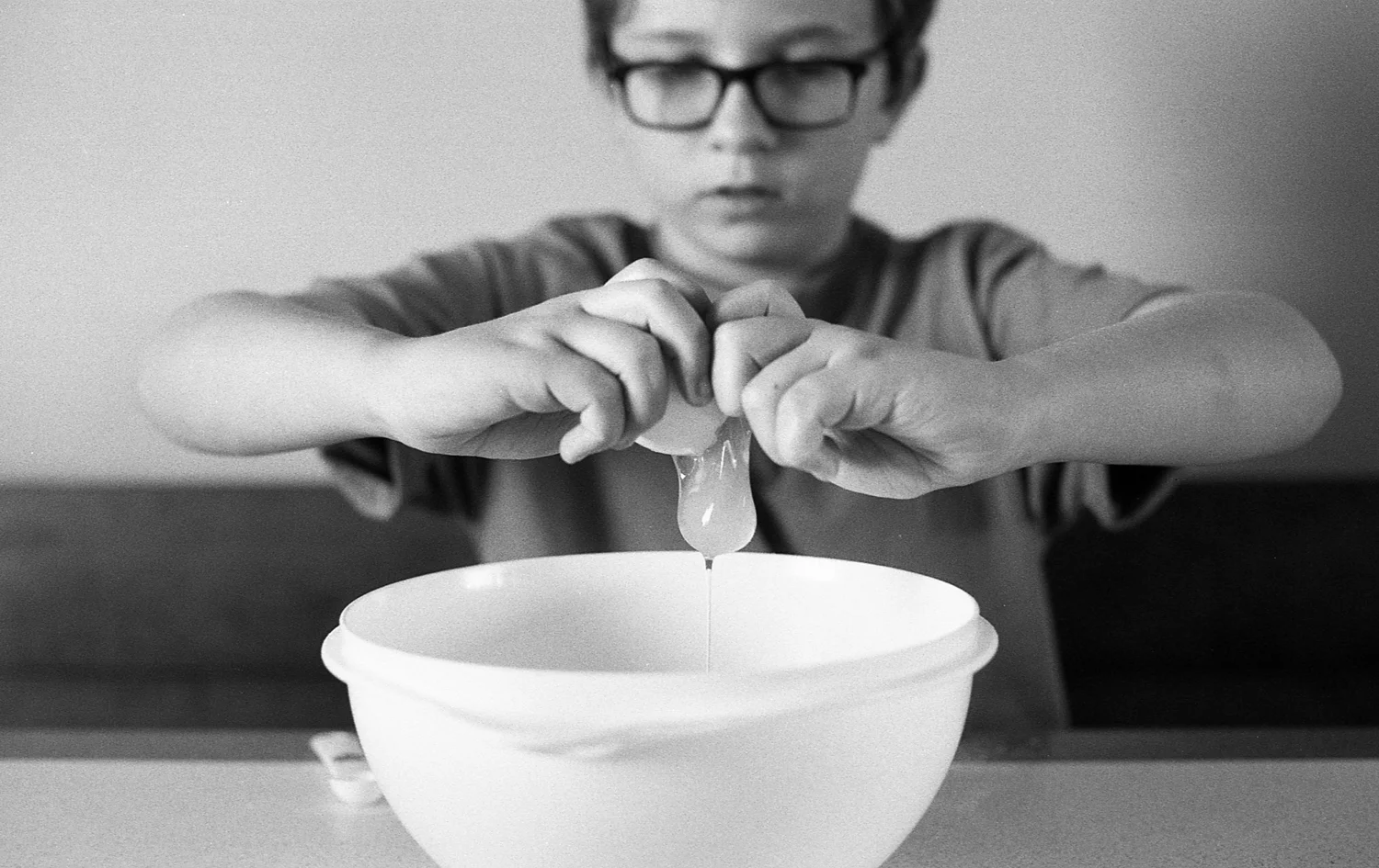 A boy baking in the kitchen.