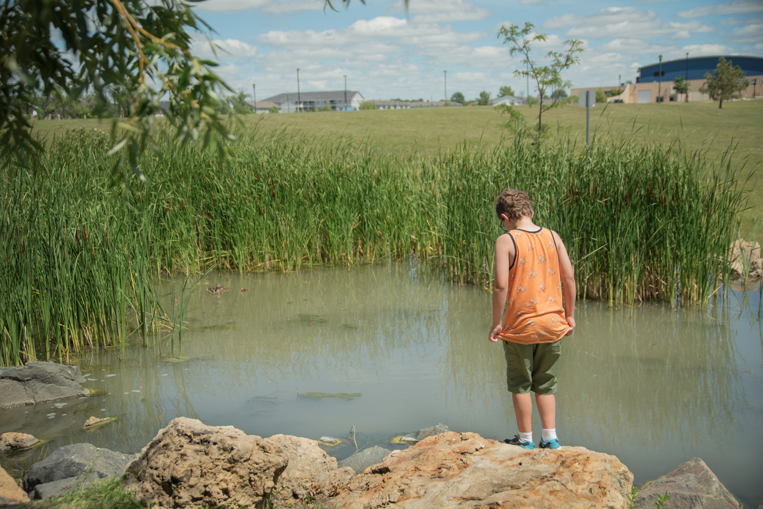 Boy-standing-pond-fargo-park