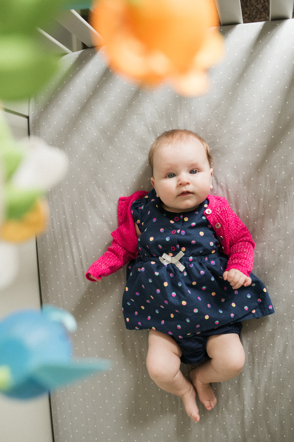 A baby girl in her crib at home.