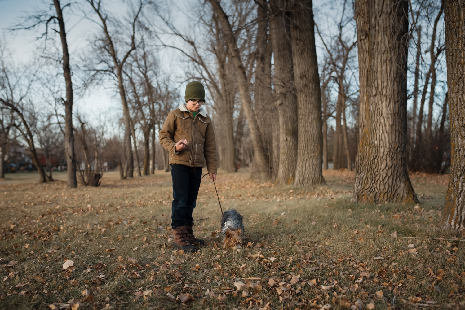 Photo by Mindy Sauvageau (www.orangemoonphotography.com) Boy and his dog walking in a park in West Fargo.