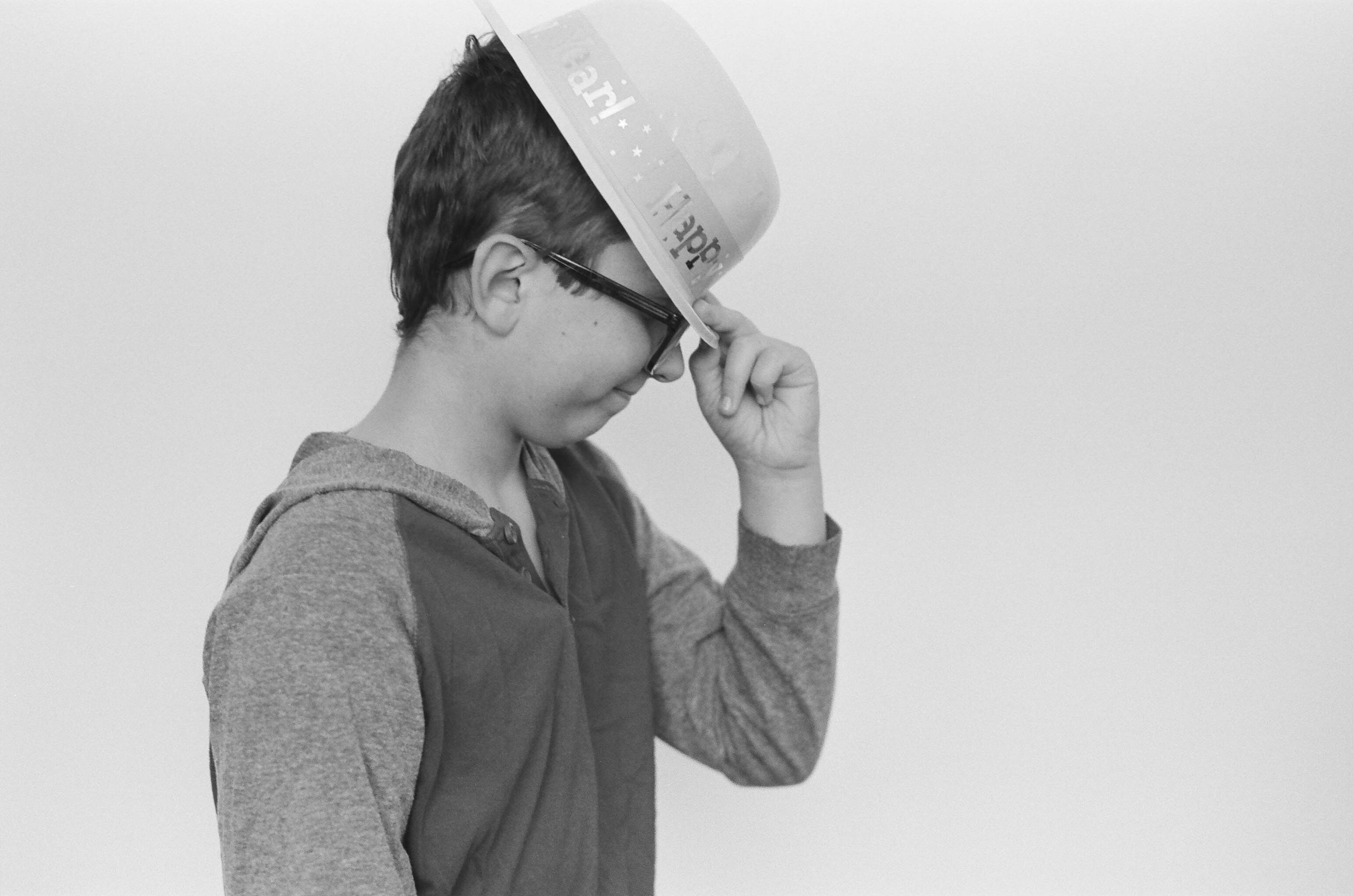 A young boy wearing a Happy New Year hat in a studio in West Fargo.