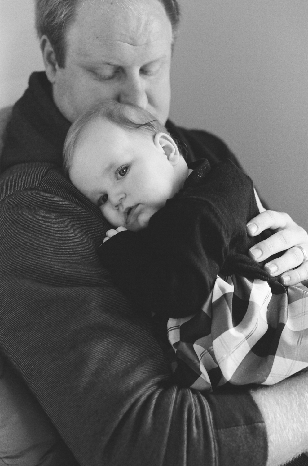 Dad holding his baby girl on his shoulder.