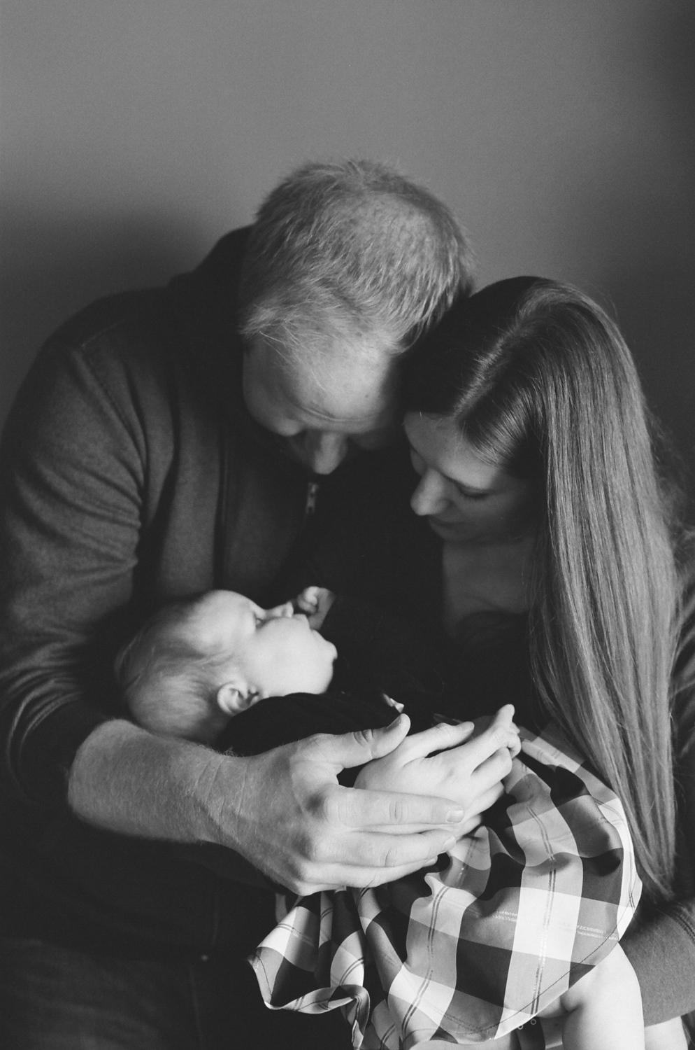 Mom and dad admiring their baby girl.