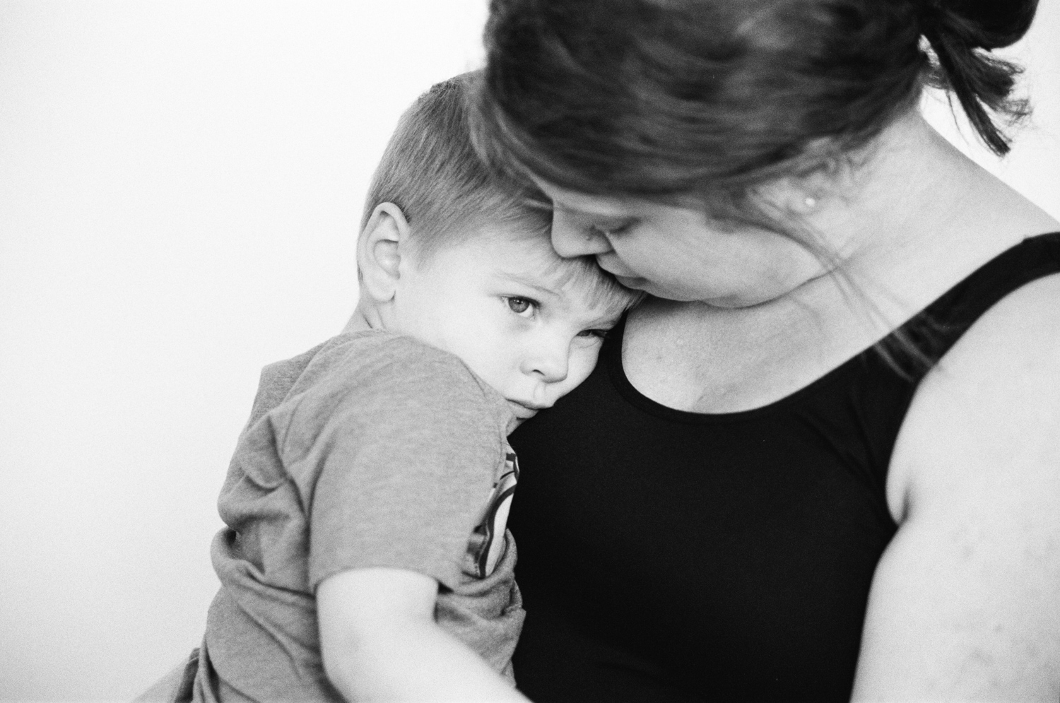 Boy sitting on his mom's lap during a Fargo family session.